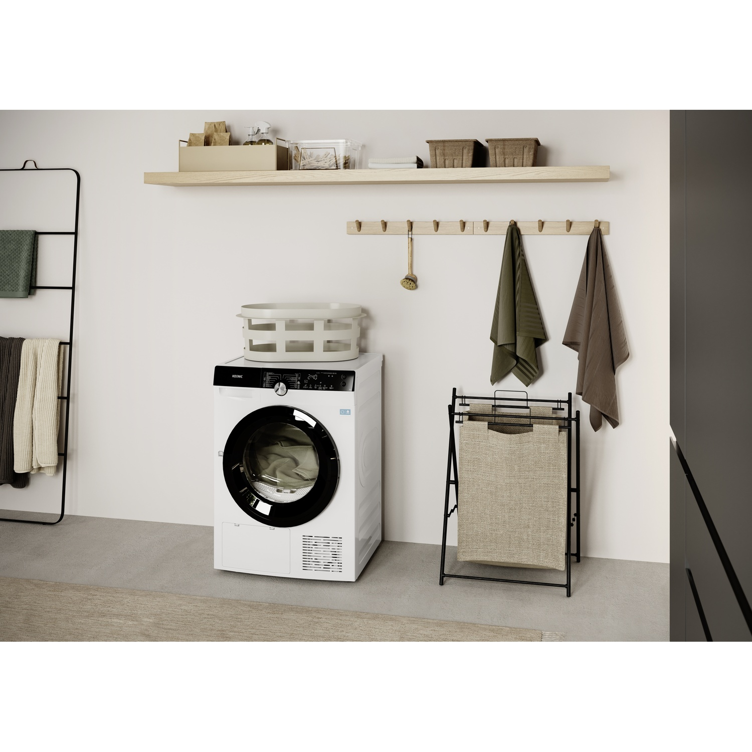 A white washing machine is in a laundry room. Towels hang on a rack. A laundry basket sits nearby. Shelves hold baskets and boxes.
