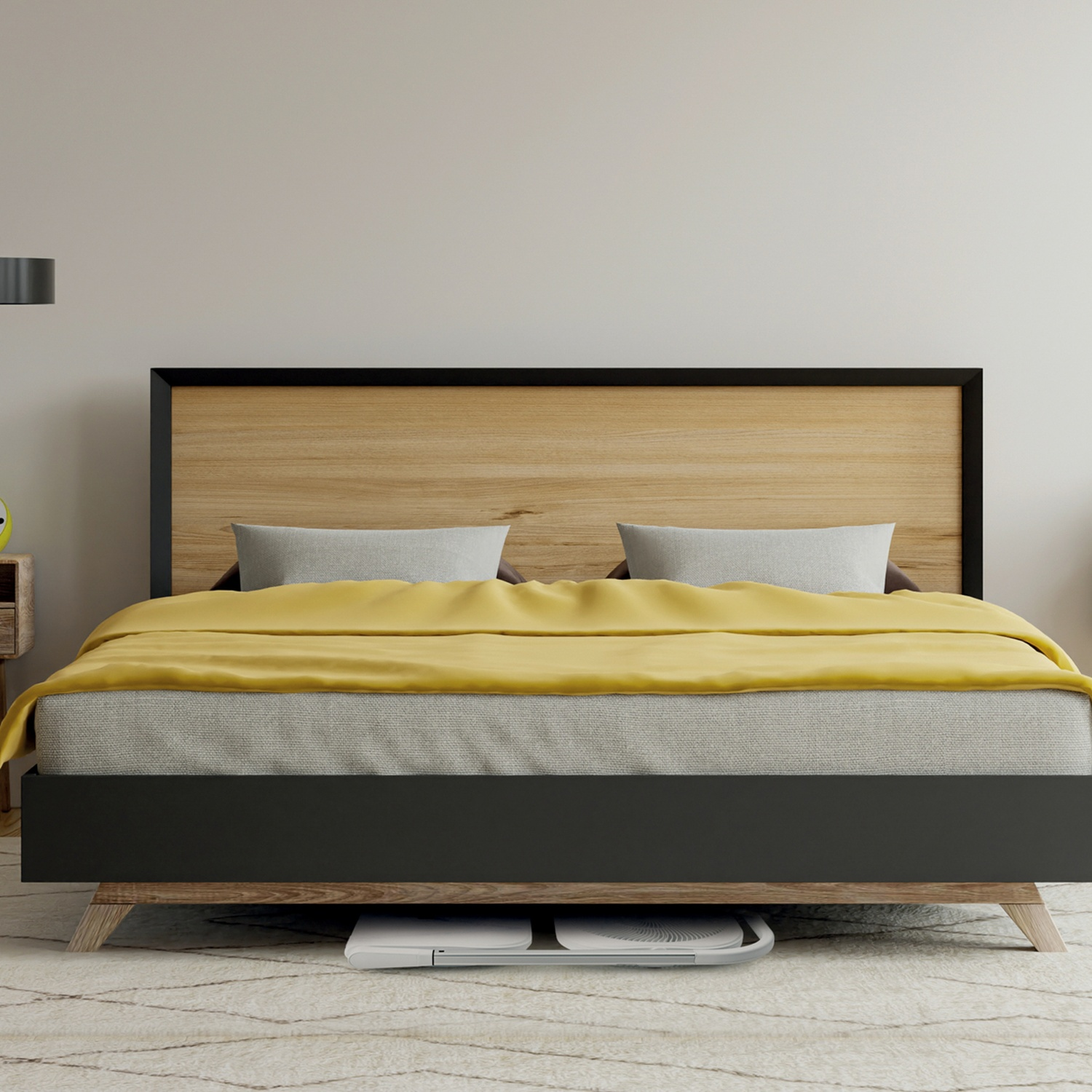 Un letto con testiera in legno, coperta gialla, cuscini grigi e struttura nera. Un tappeto è sul pavimento.