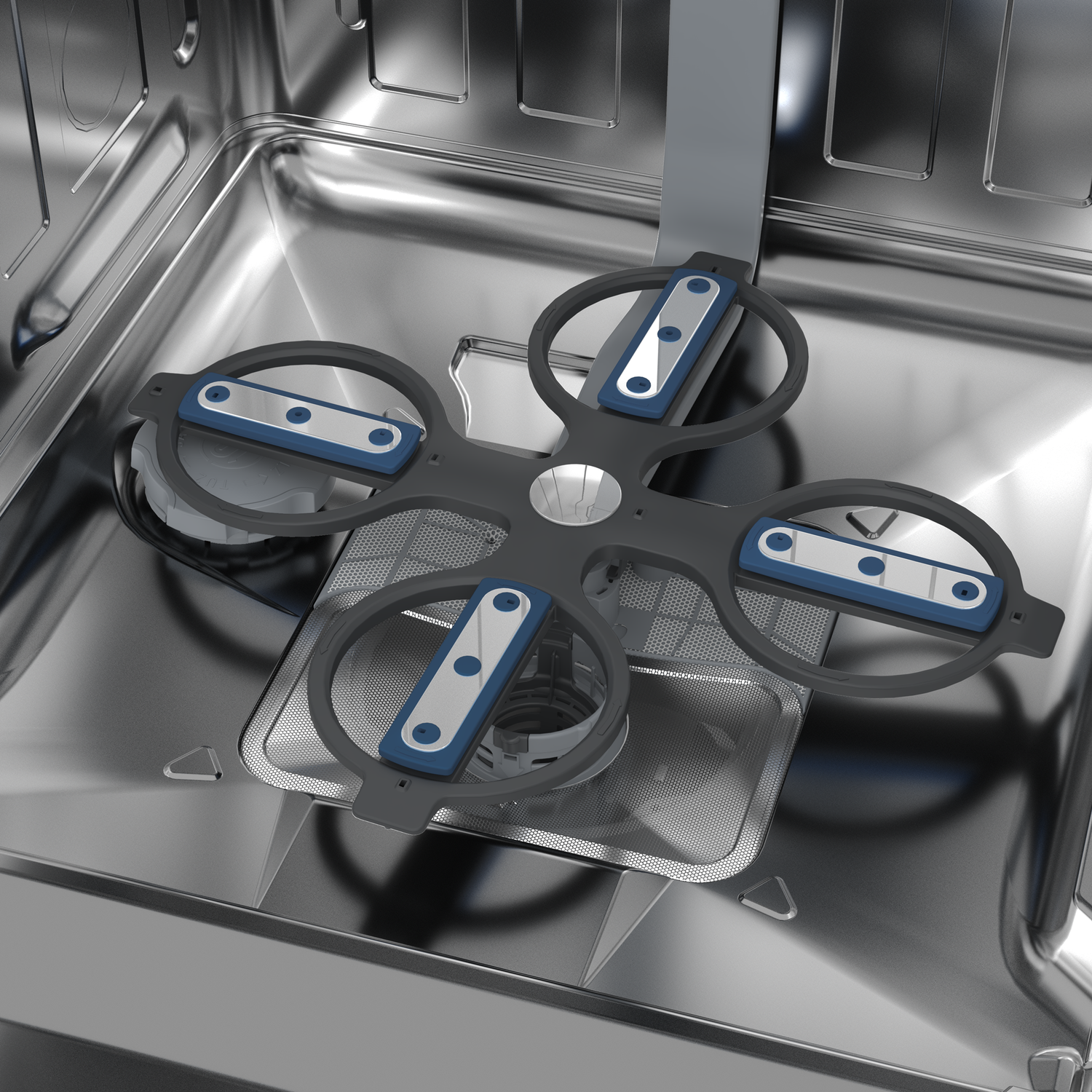 Inside a dishwasher, a gray rotating spray arm with blue and silver details. The interior is stainless steel.
