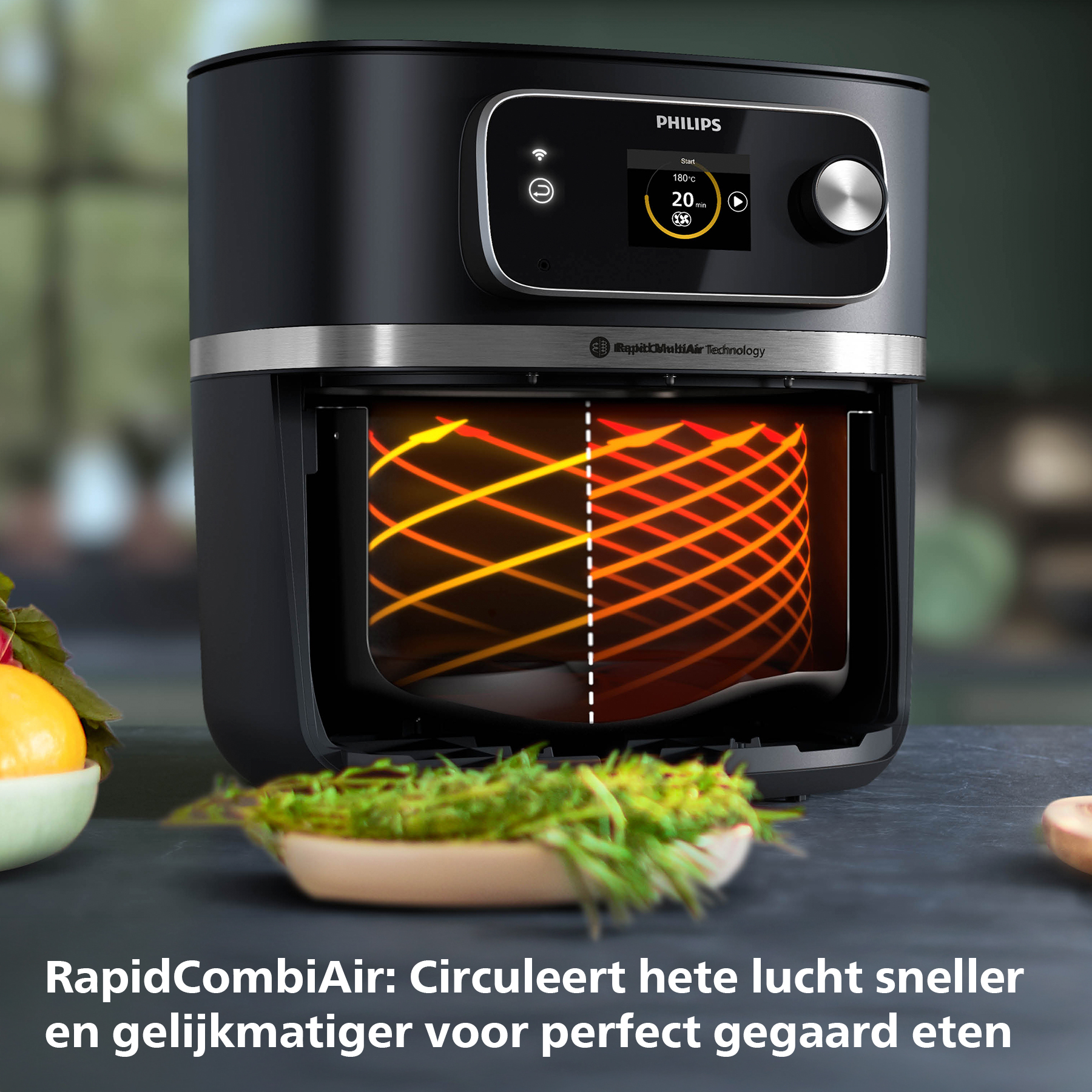Black Philips air fryer with digital display. Inside, orange lines show air circulation. Bowls of food are in the foreground.