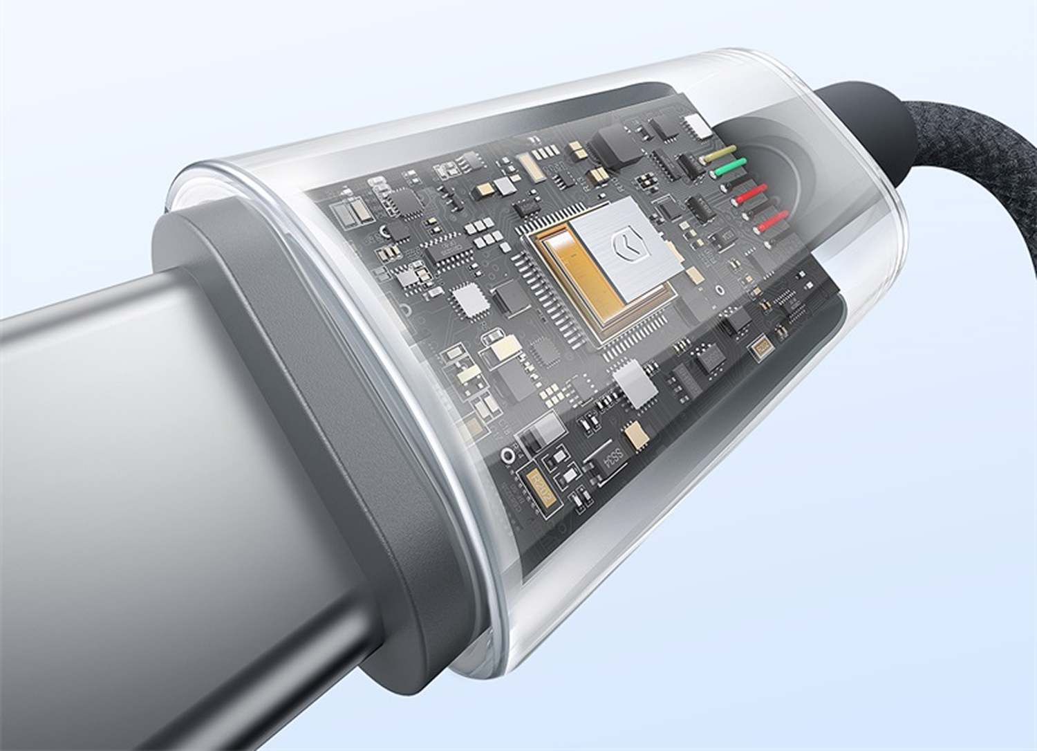 Primer plano de un conector de cable USB-C con una carcasa transparente, que muestra el circuito interno y los cables. El cable es gris y negro.