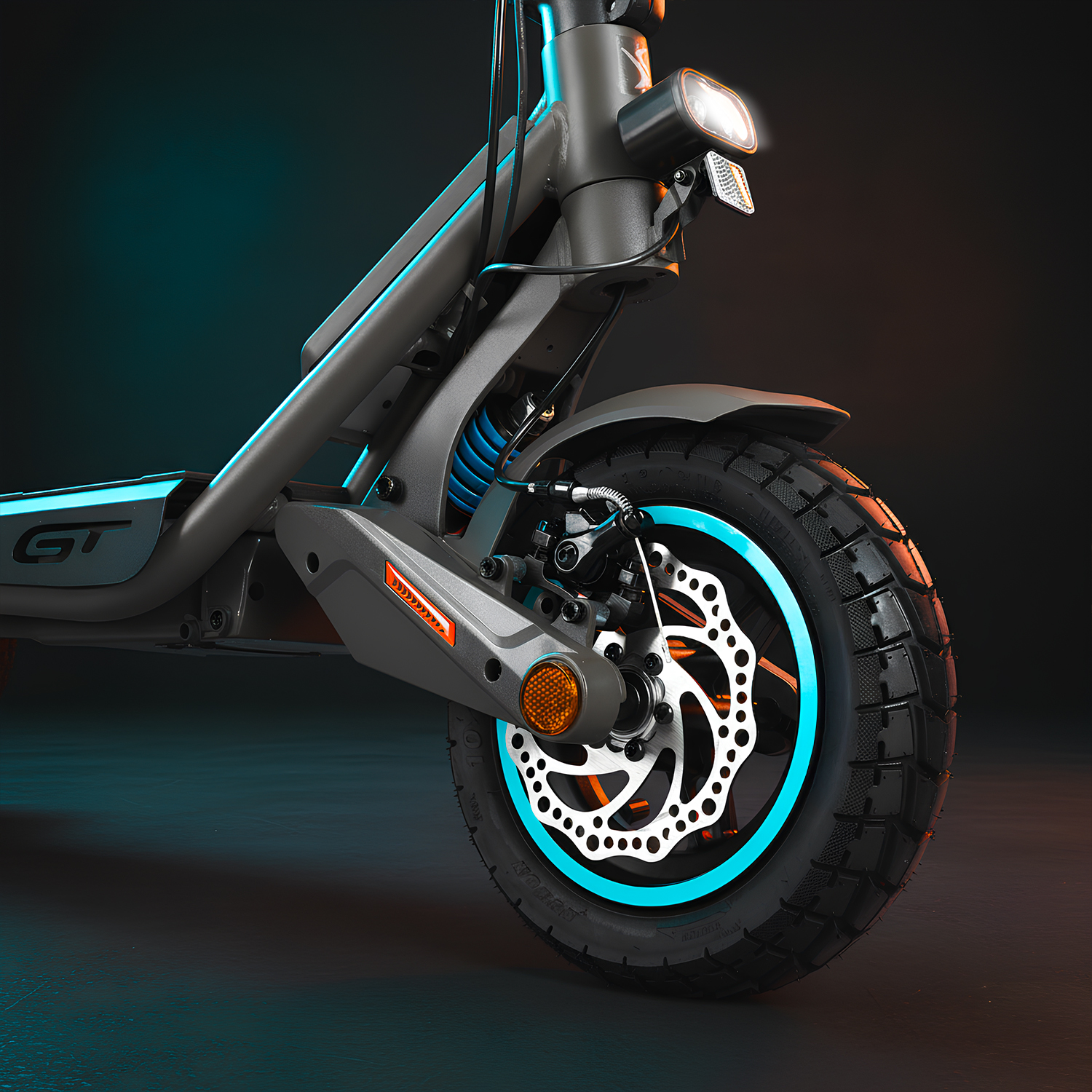 Primer plano de un patinete eléctrico. La rueda delantera tiene un neumático negro, un disco de freno plateado con borde azul y un faro.