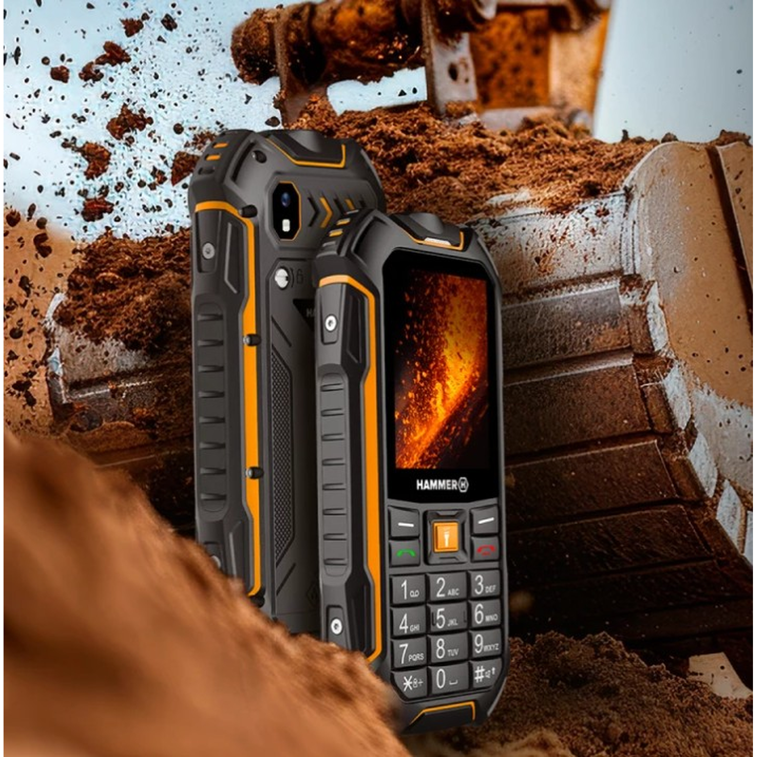 Two black and orange rugged phones. One displays a fiery image. An excavator with dirt is in the background.
