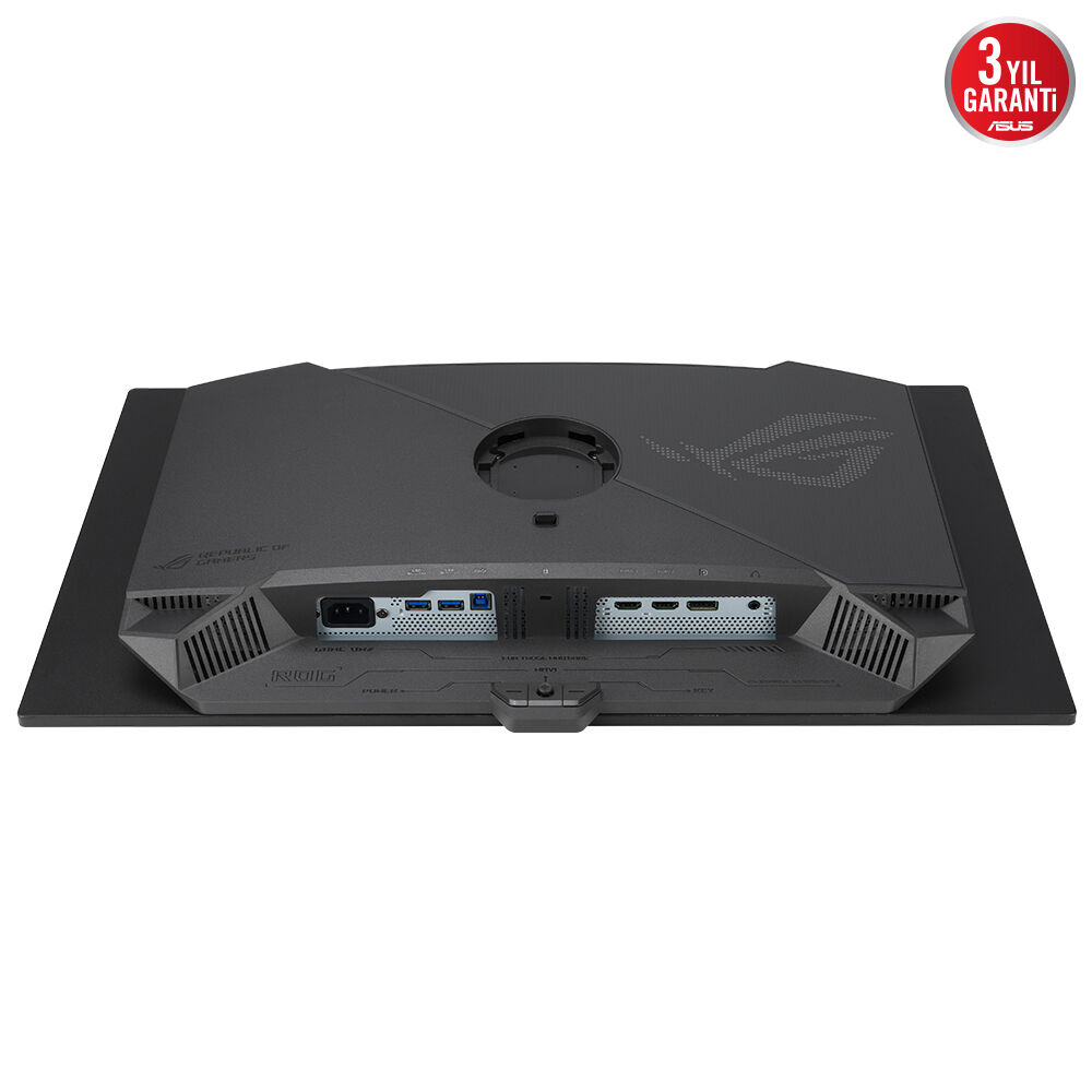 Siyah bir bilgisayar monitörünün arkası. Bağlantı noktaları, ROG logosu ve bir ASUS garanti etiketi var.