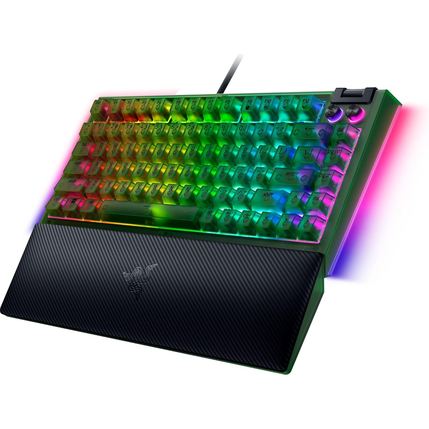 A Razer keyboard with transparent keys illuminated by rainbow colors. The keyboard has a black wrist rest with the Razer logo.