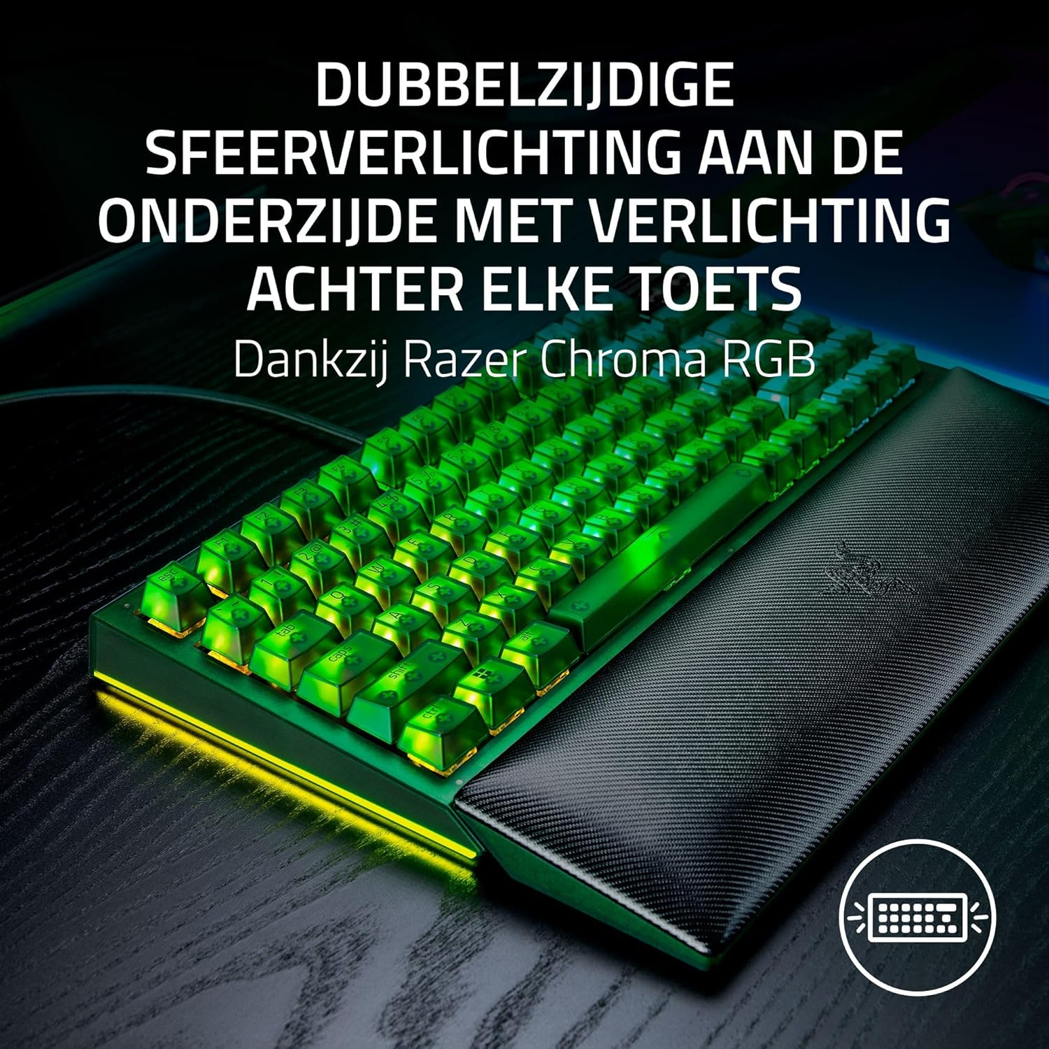 A green backlit keyboard with a wrist rest. The keys are illuminated in green. A Razer Chroma RGB logo is visible.
