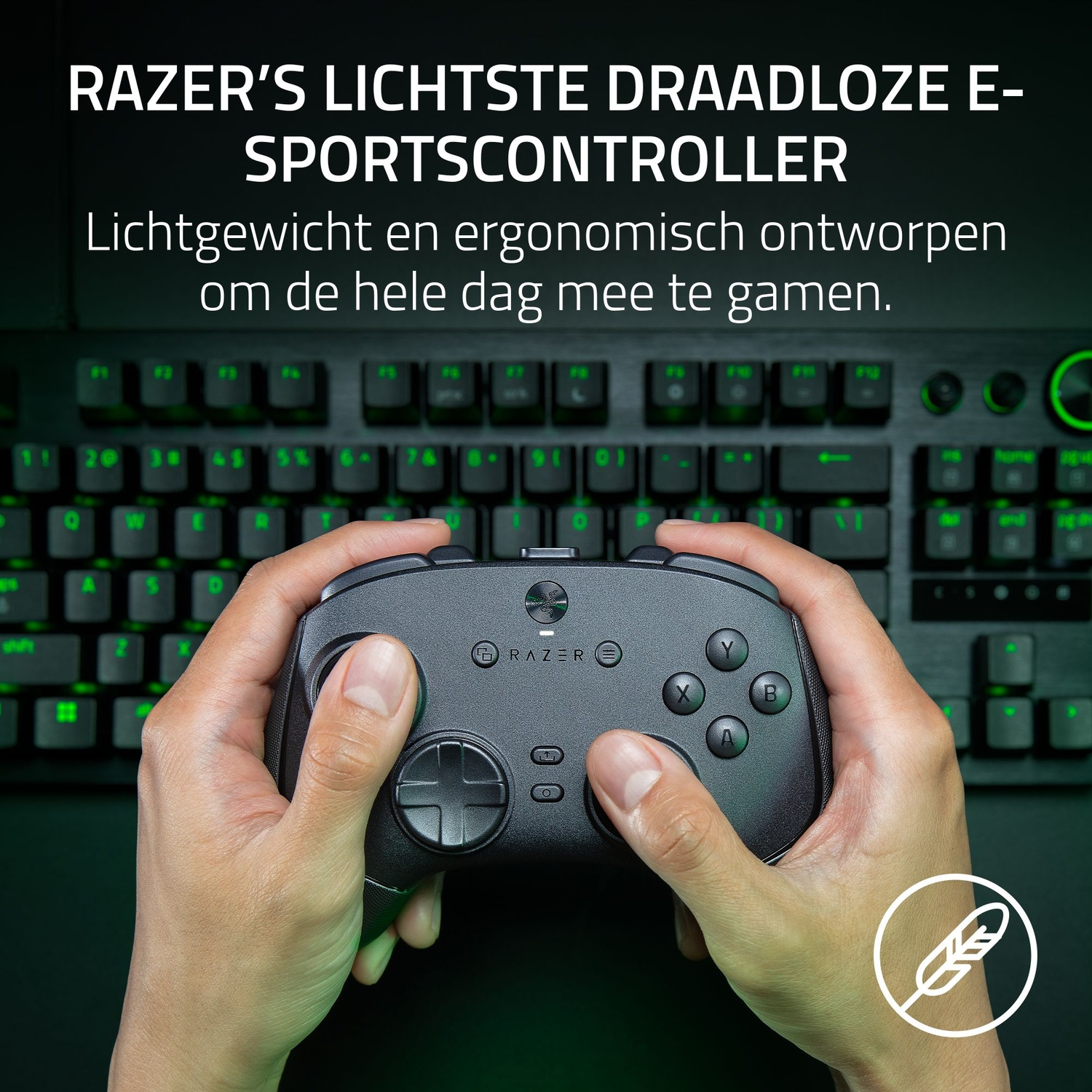 Hands holding a black Razer wireless e-sports controller. A keyboard is in the background. Feather icon on the bottom right.