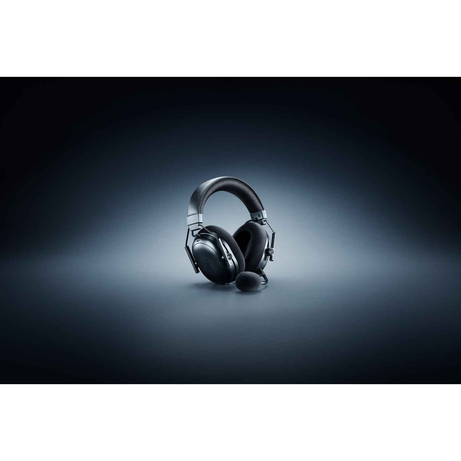 Black gaming headset with a microphone, set against a dark gradient background. The headset is centered and well-lit.