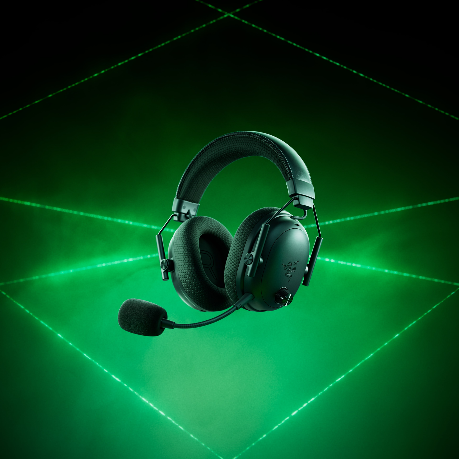 Black gaming headset with a microphone. It has green accents and is set against a green, geometric background with lines.