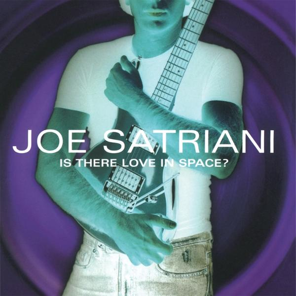 Album borító. Joe Satriani gitárt tart, fehér pólót és farmert visel. Lila háttér 'Is There Love In Space?' szöveggel.