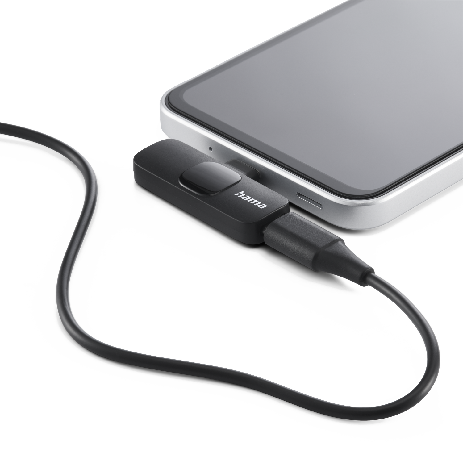 A black Hama device connected to a smartphone via a cable. The phone is silver-framed, and the background is white.