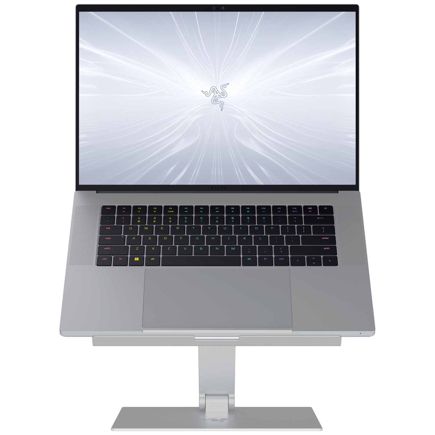 A silver laptop with a bright screen displaying a white Razer logo. It rests on a silver stand, and the keyboard is visible.