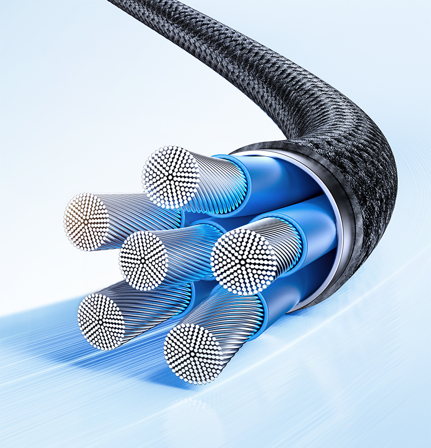 Primer plano del extremo cortado de un cable, que revela los cables internos. Los cables son plateados, envueltos en azul, con un exterior trenzado negro.