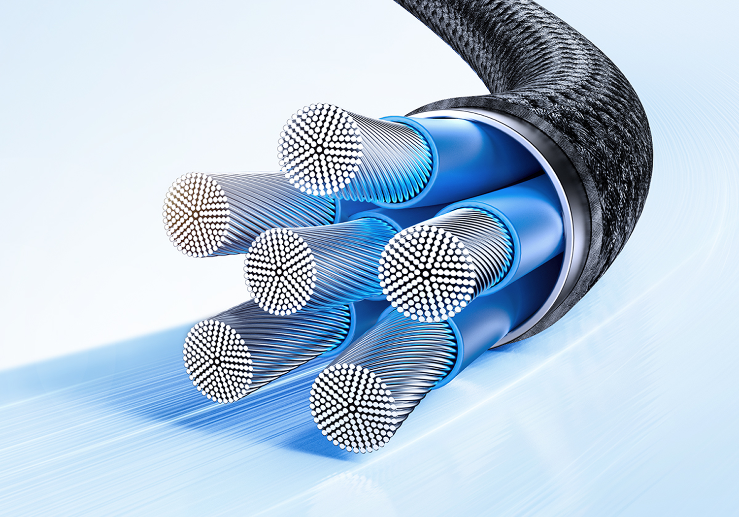 Primer plano de un cable con múltiples cables internos, tubos azules y una capa exterior trenzada negra. El fondo es azul claro.