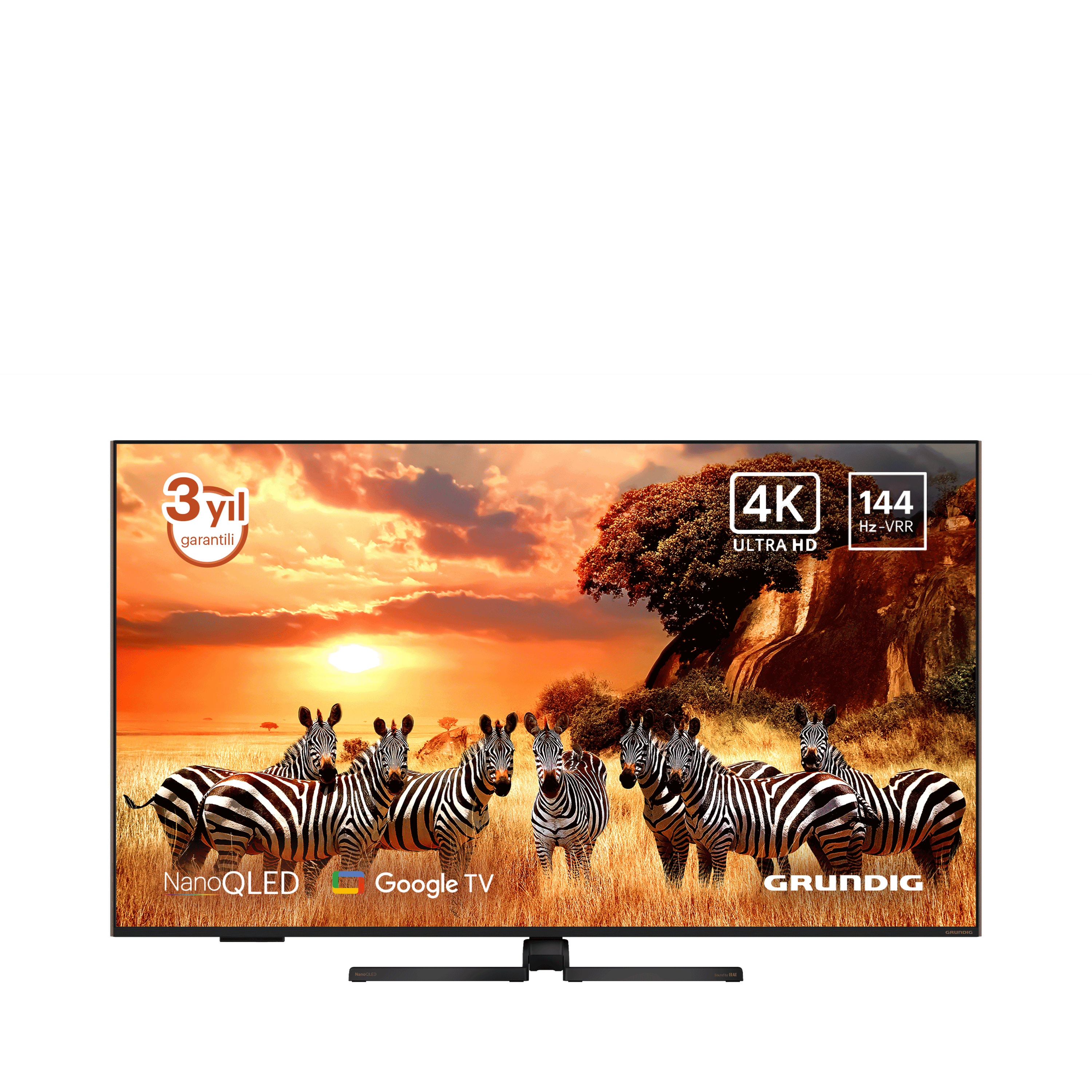 TV ekranında gün batımında savanda zebralar görülüyor. Markalar: Grundig, Google TV ve NanoQLED.
