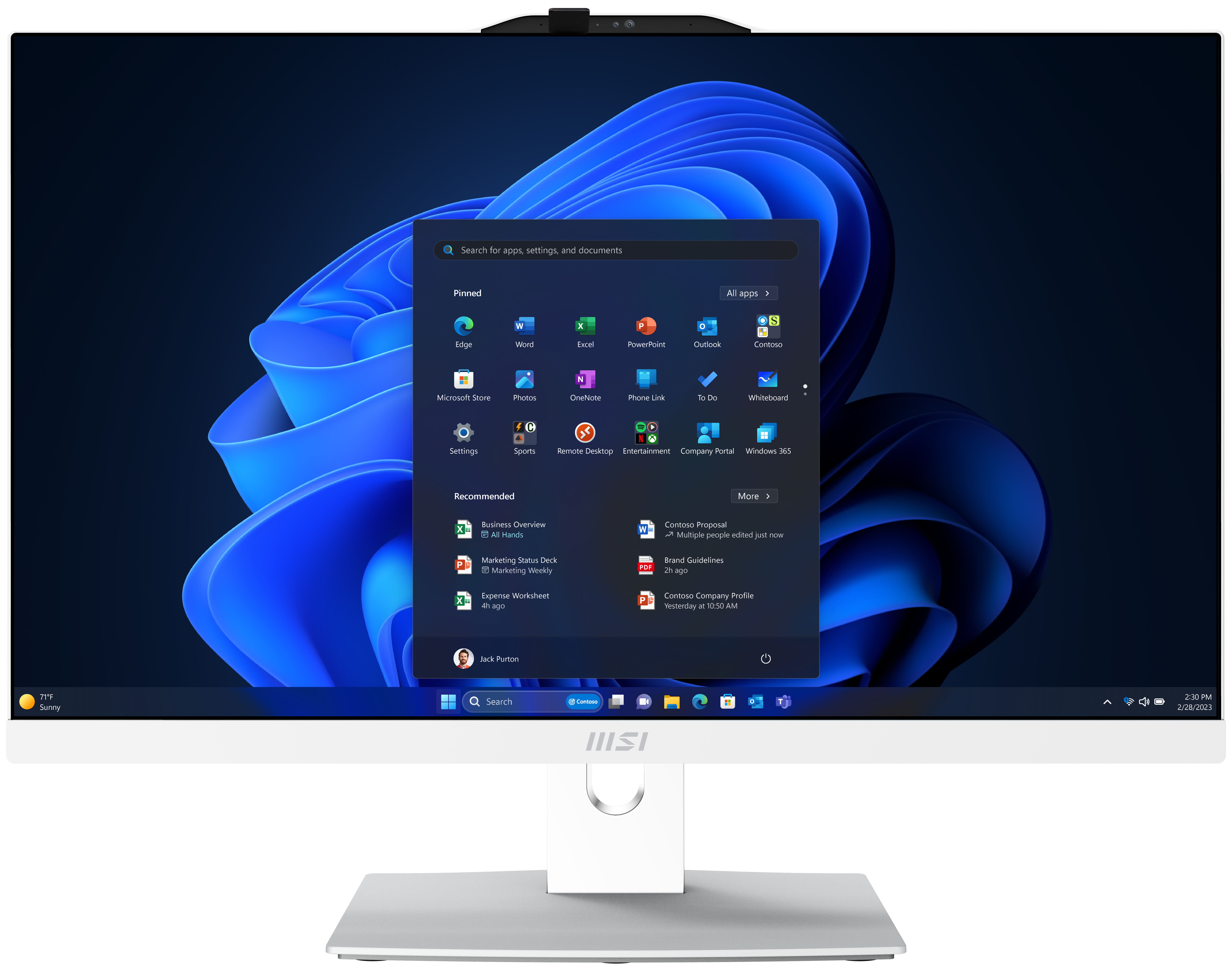 Ein weißer MSI-All-in-One-Computer zeigt einen Windows 11-Desktop mit App-Symbolen und blauem Hintergrund.