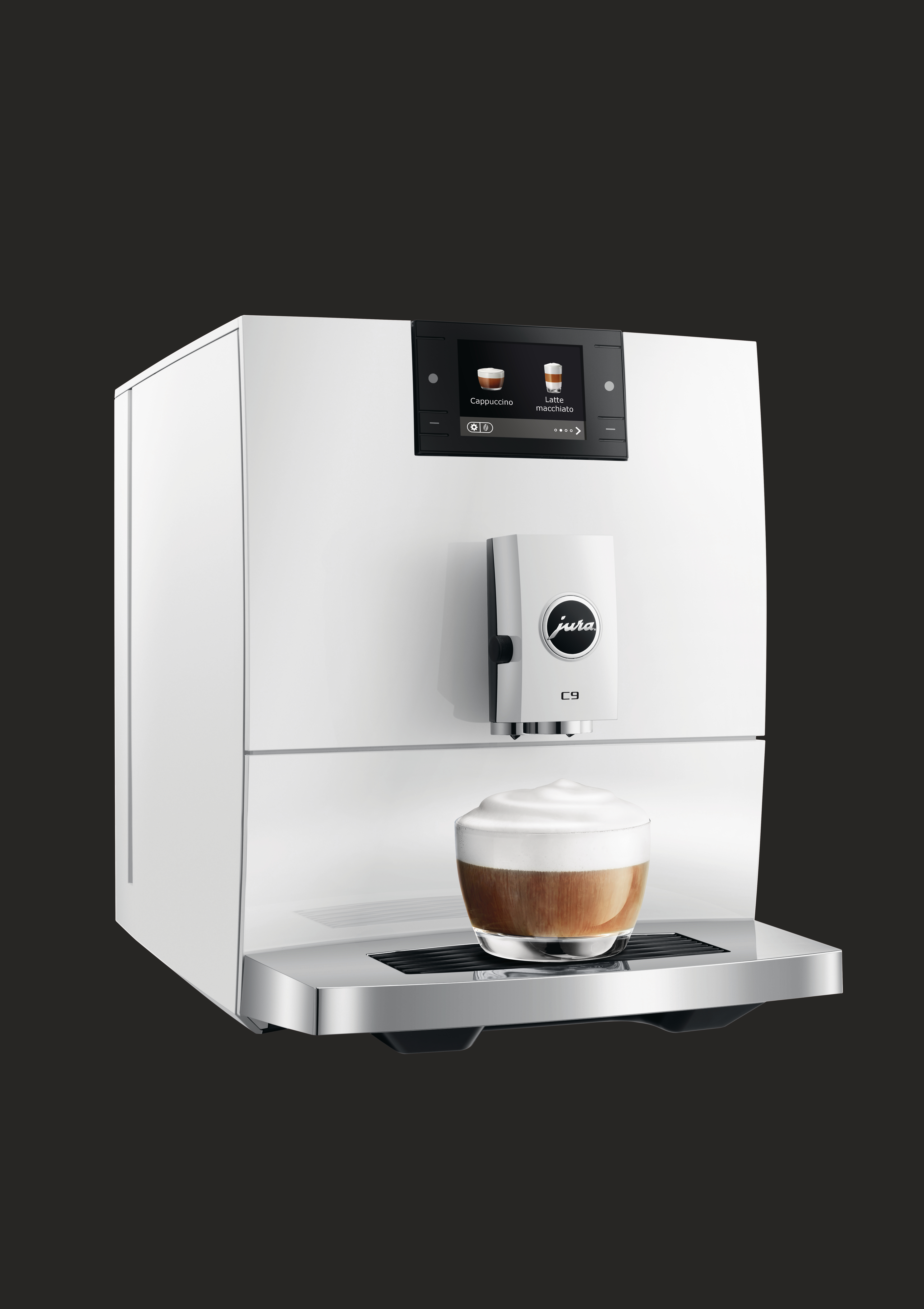 Eine weiße Jura C9 Kaffeemaschine mit einem Cappuccino im Glas. Schwarzer Hintergrund.