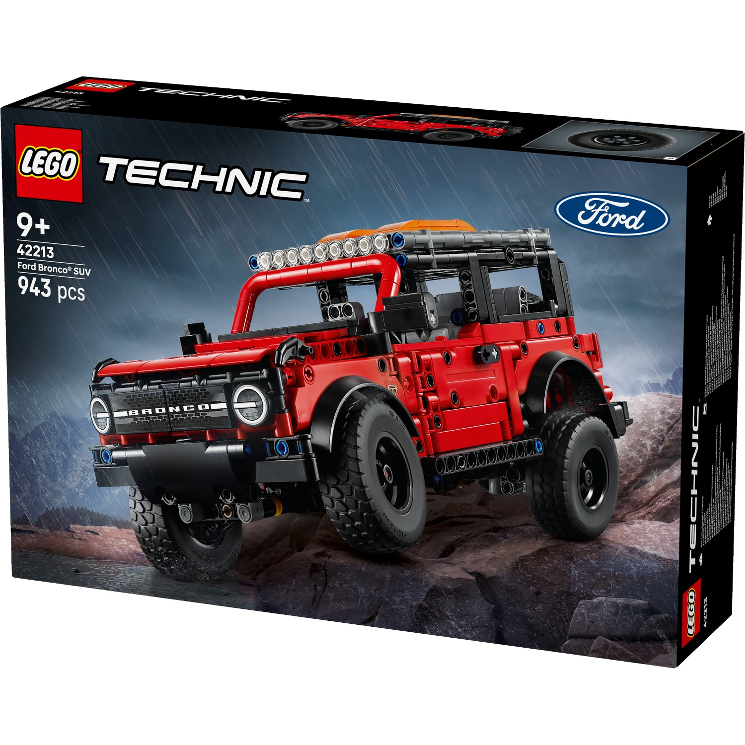 A Lego Technic box shows a red Ford Bronco SUV model. It's on a rocky surface with a stormy background. The box says 943 pieces.