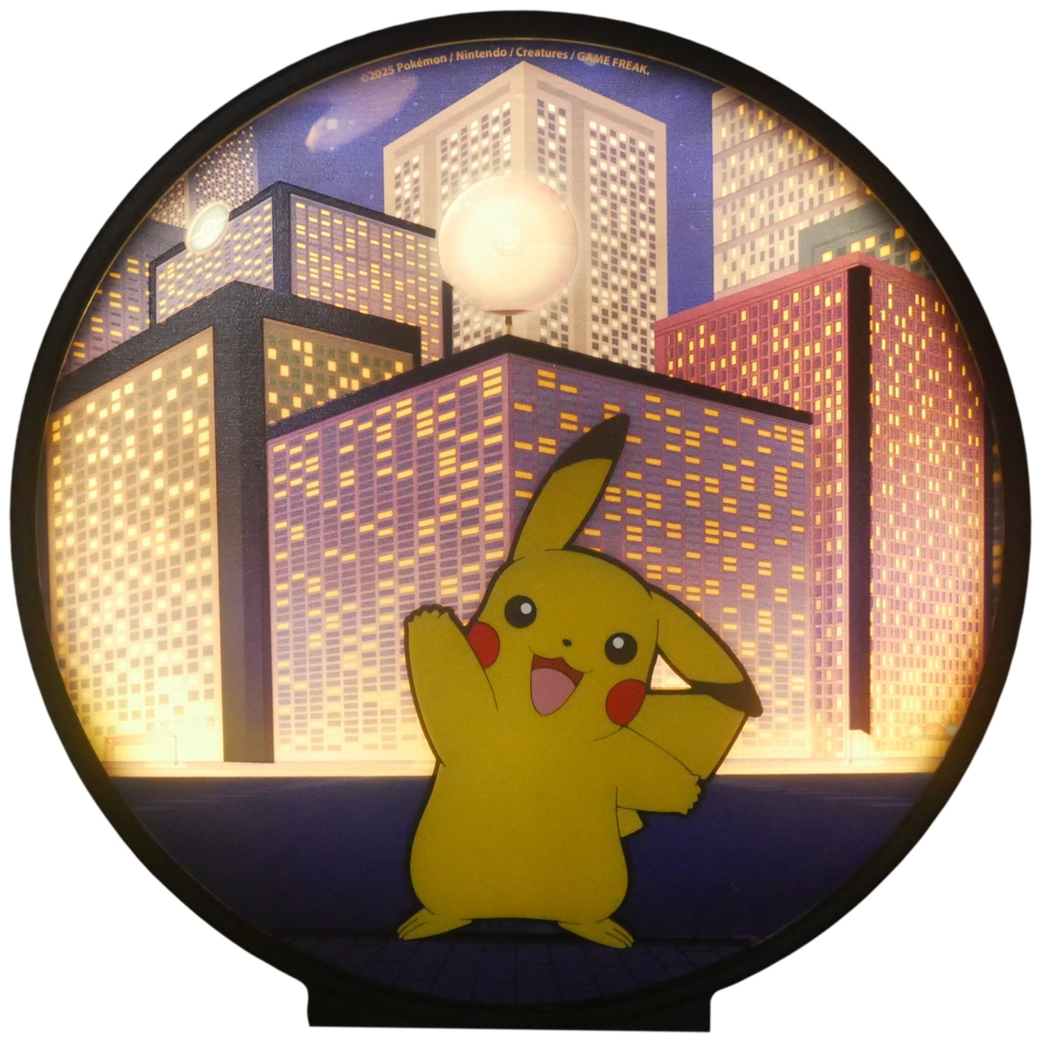 Pikachu in a city scene, arms raised. Buildings with lit windows in the background. Circular frame with a black base.