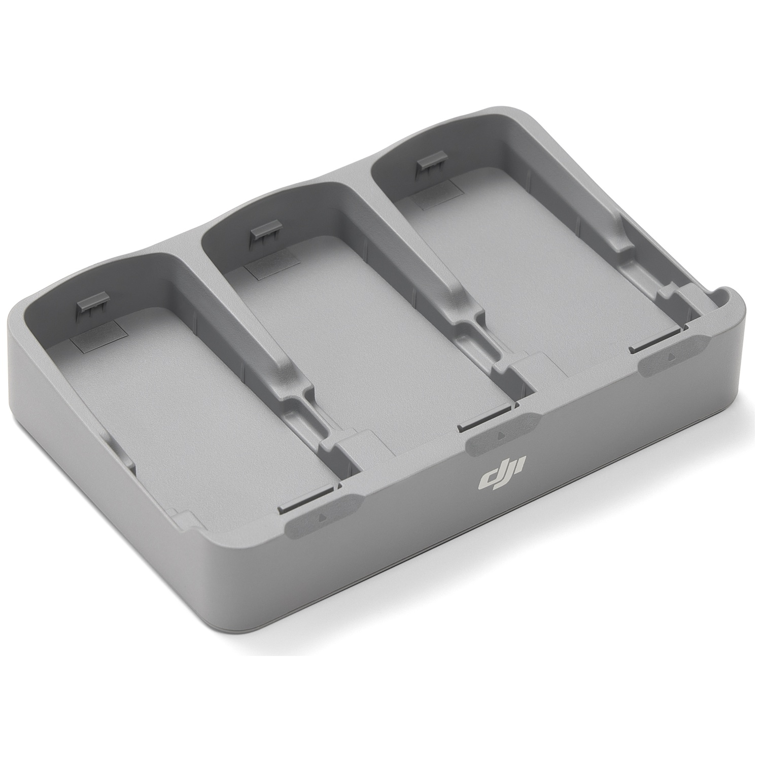 A gray charging station with three slots. The DJI logo is visible. The station is on a white background.