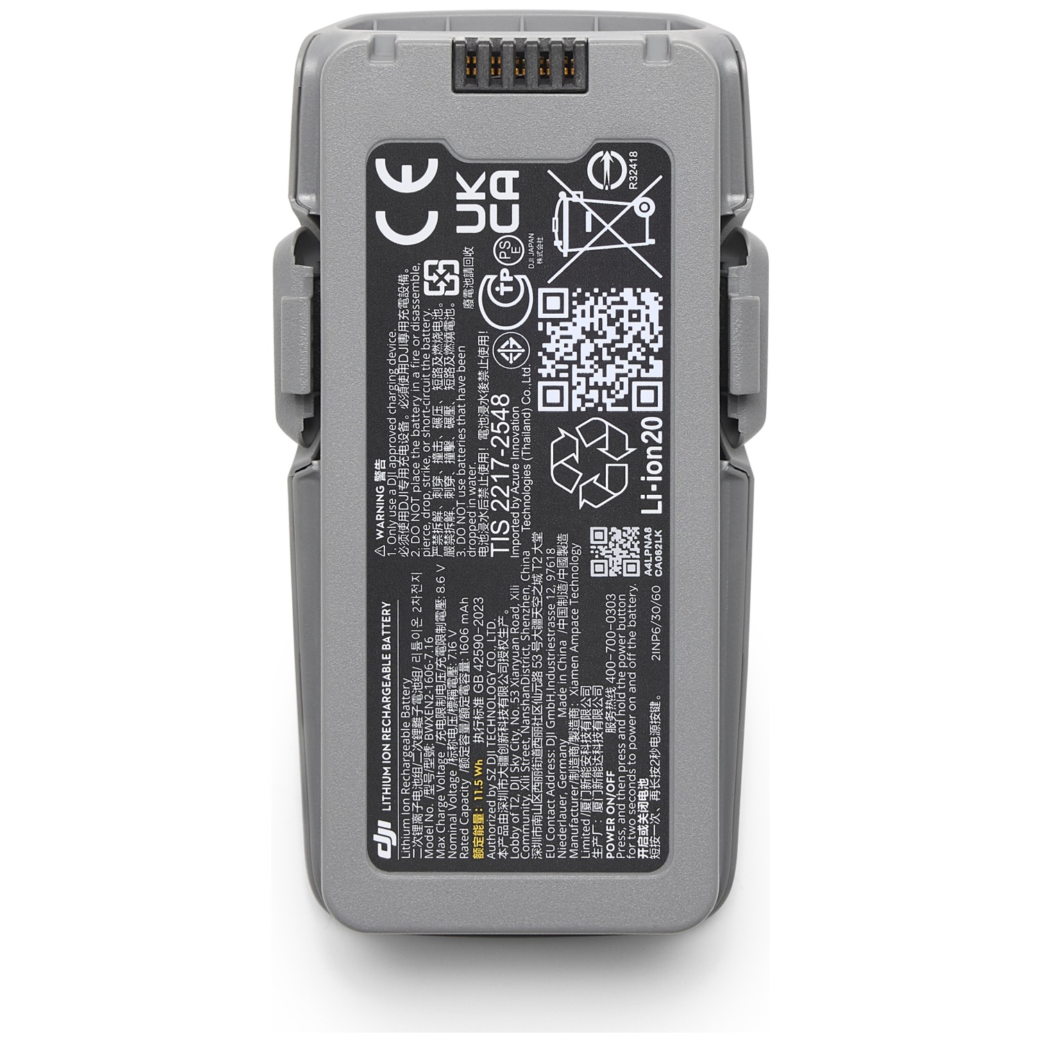 A gray DJI battery with text and symbols. It has a warning label and a QR code.