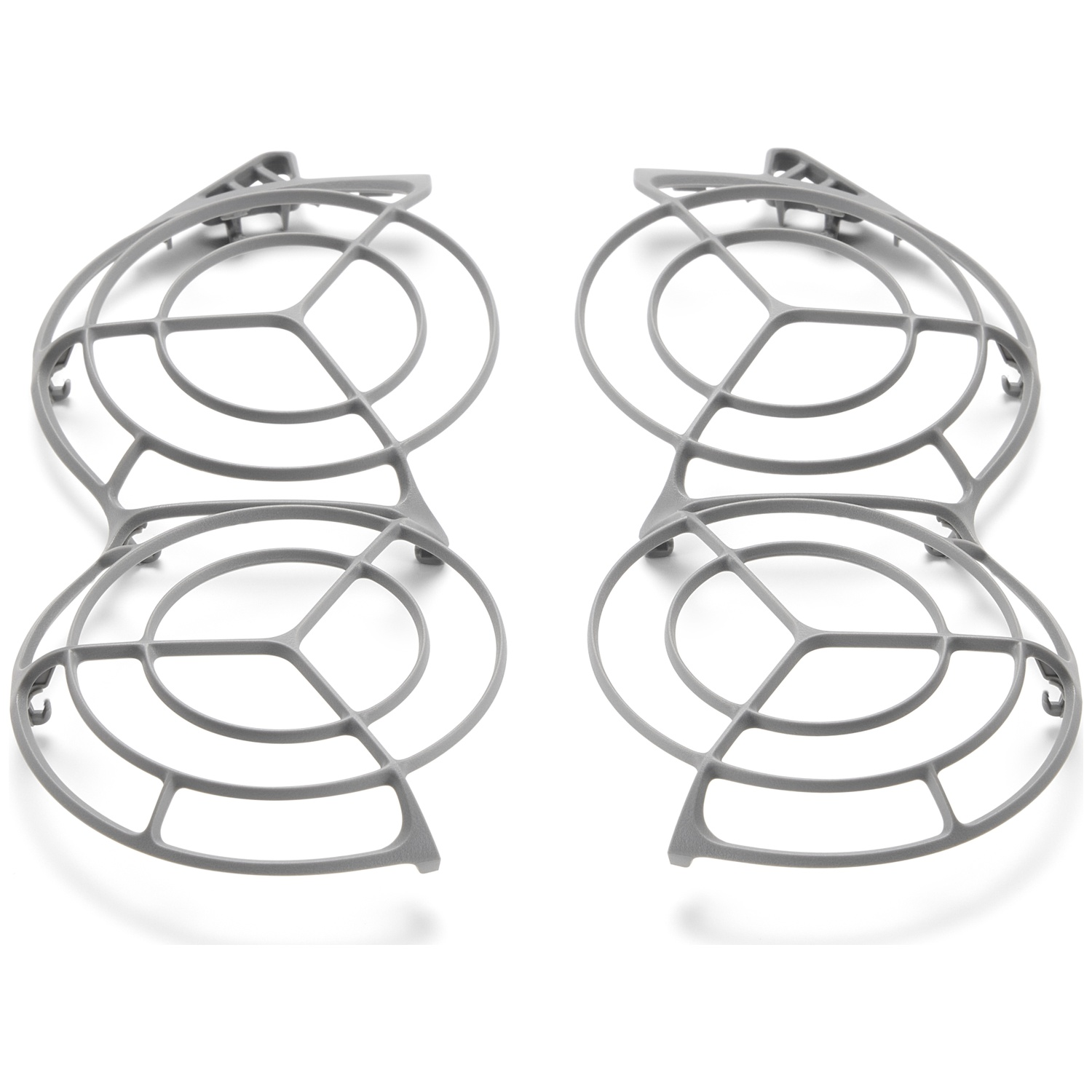 Deux grilles de ventilateur en plastique gris sur fond blanc. Chacune a un design circulaire et géométrique avec de multiples ouvertures.