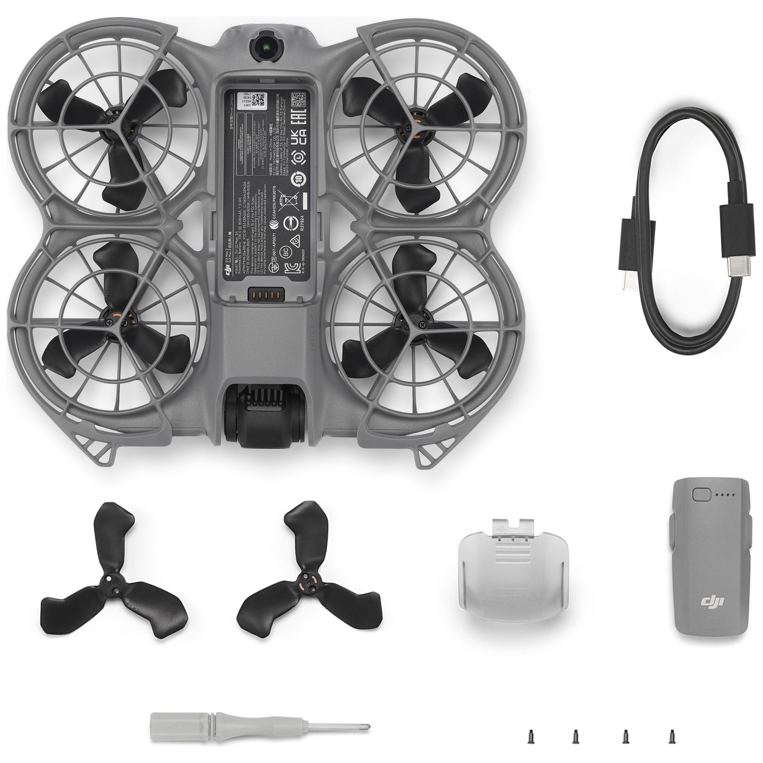 Drone components laid out, including the drone body, propellers, charger, cable, and screws. Gray and black colors dominate.