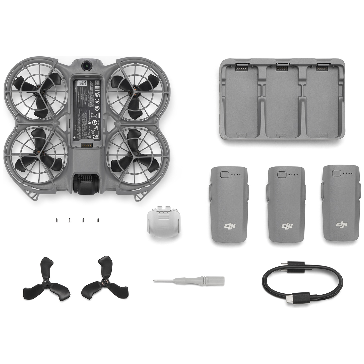 Drone components laid out: drone body, propellers, batteries, charger, charging case, screws, screwdriver, and a USB-C cable.