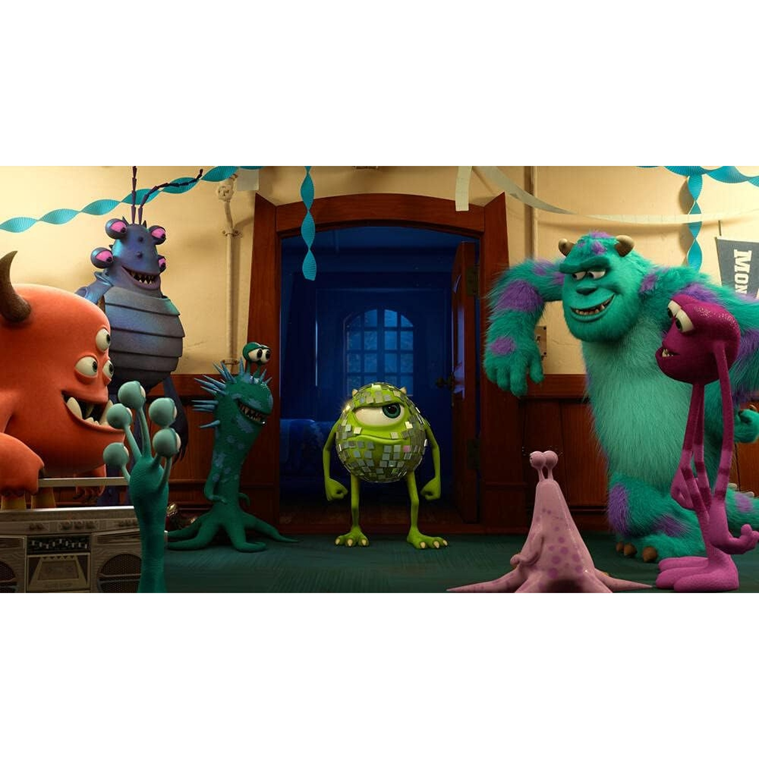Monsters Inc. characters gather in a room. Sully, Mike, and other colorful monsters are present. The scene is indoors.