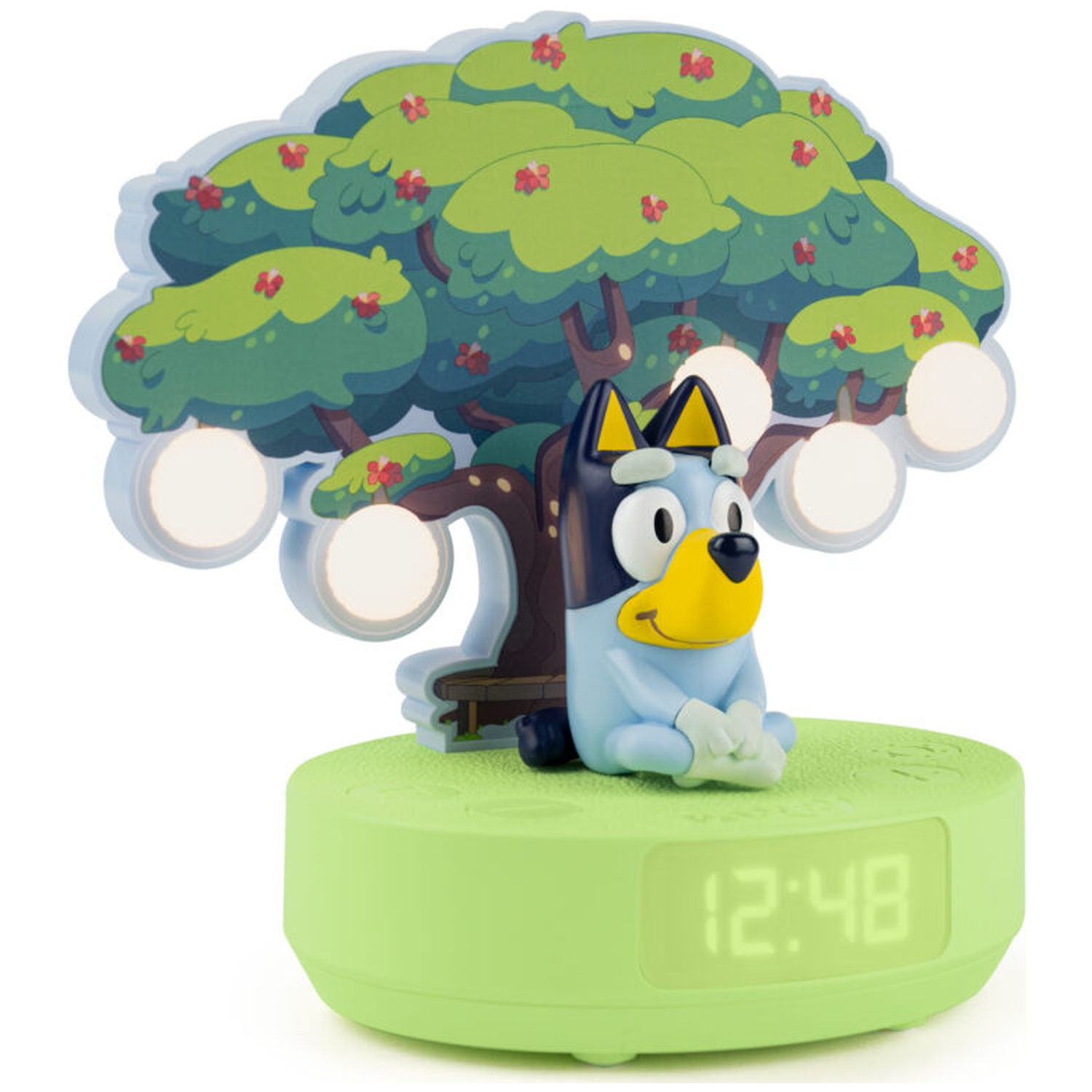 Bluey figure sits on a green clock base with a tree backdrop. The clock shows 12:48. Tree has flowers and lights.