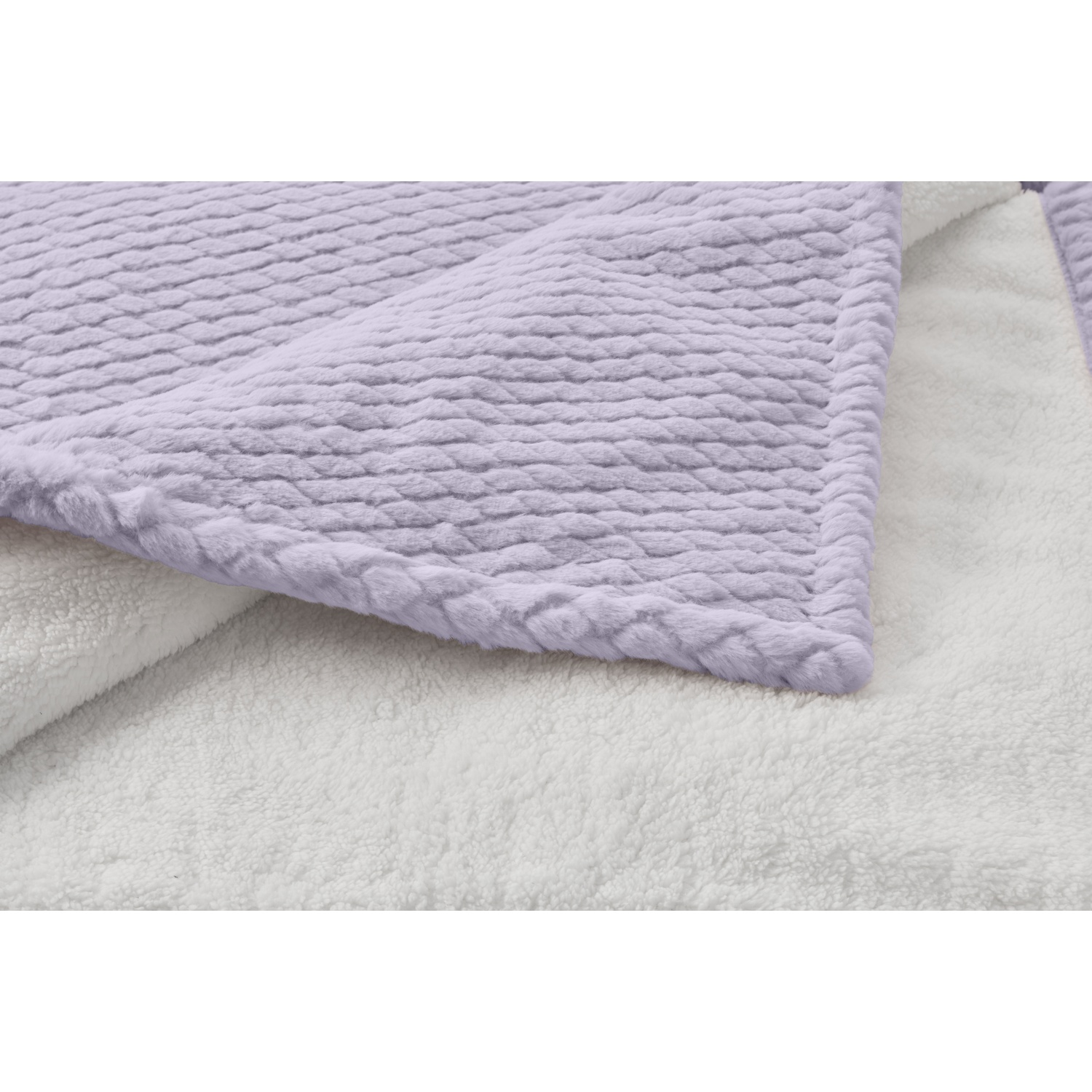 A close-up of a soft blanket. The top layer is lavender with a textured pattern. The bottom is white, fluffy fabric.