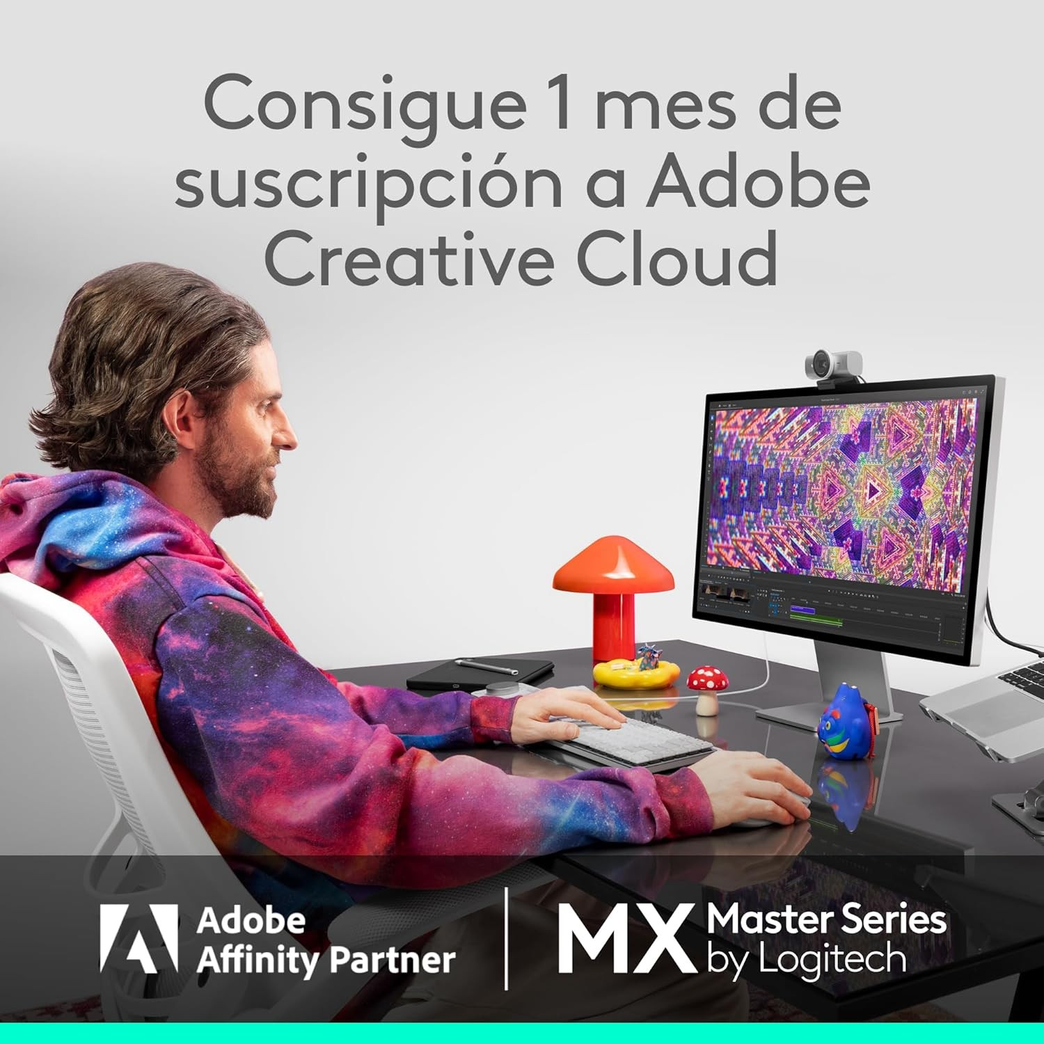 Hombre en escritorio usa computadora. Pantalla muestra diseño colorido. Logos Adobe, Logitech. Texto: Adobe Creative Cloud.
