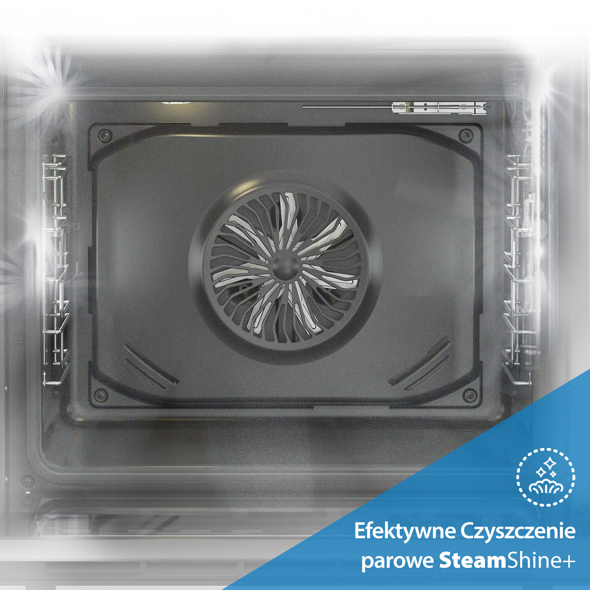 Widok wewnątrz piekarnika. Wentylator jest na środku. Widoczne są półki po bokach. Piekarnik jest szary i czysty.