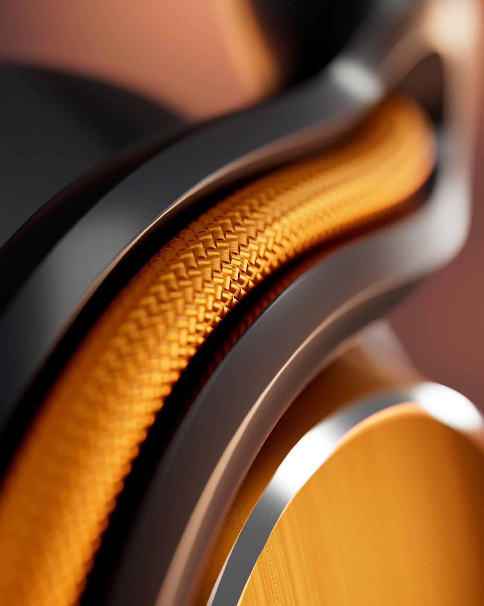 Nahaufnahme eines gewebten orangefarbenen Kabels, das sich durch gebogene, dunkelgraue und goldene Metallstrukturen windet.