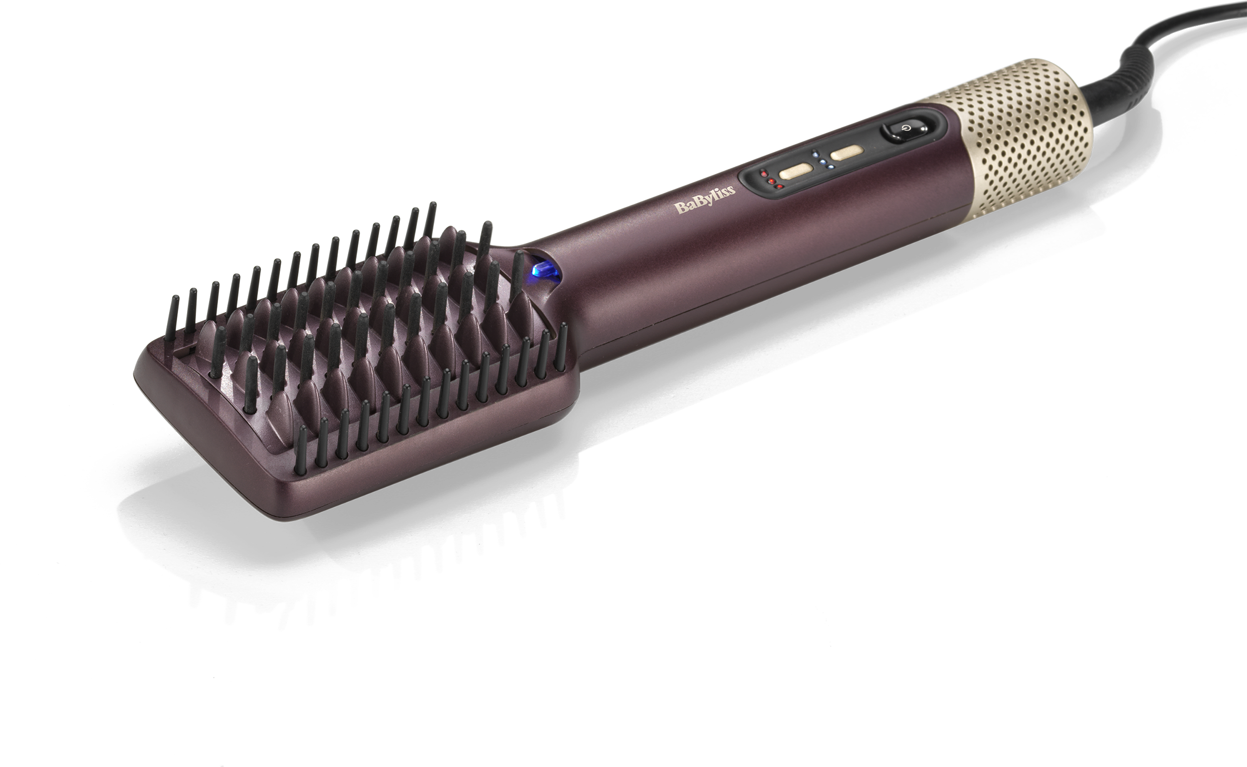 Sötétlila Babyliss melegített hajkefe fekete sörtékkel. A fogantyú arany, és van rajta bekapcsológomb.