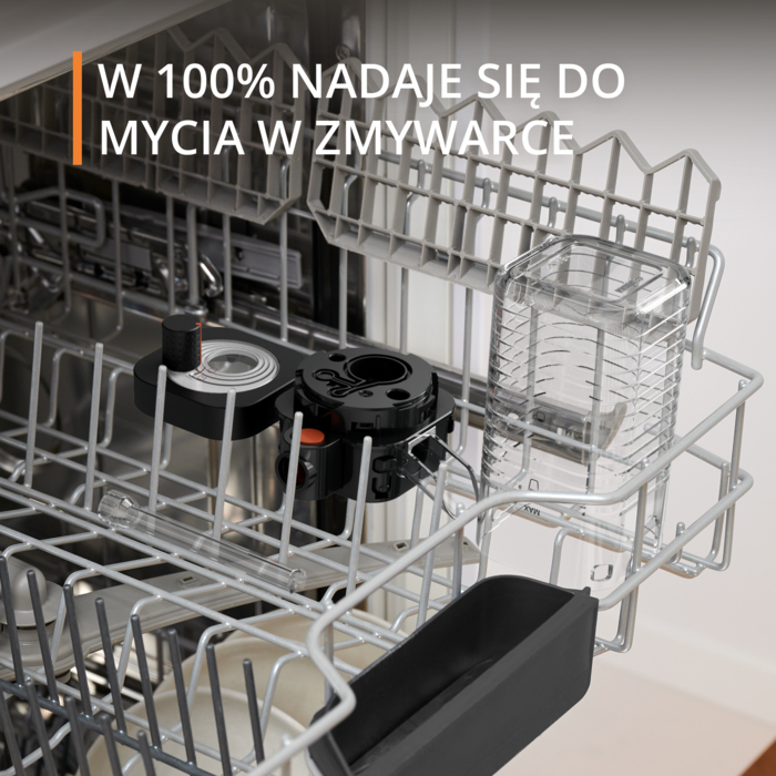 Wnętrze zmywarki z czarnymi i przezroczystymi częściami. U góry tekst mówi '100% nadaje się do mycia w zmywarce'.