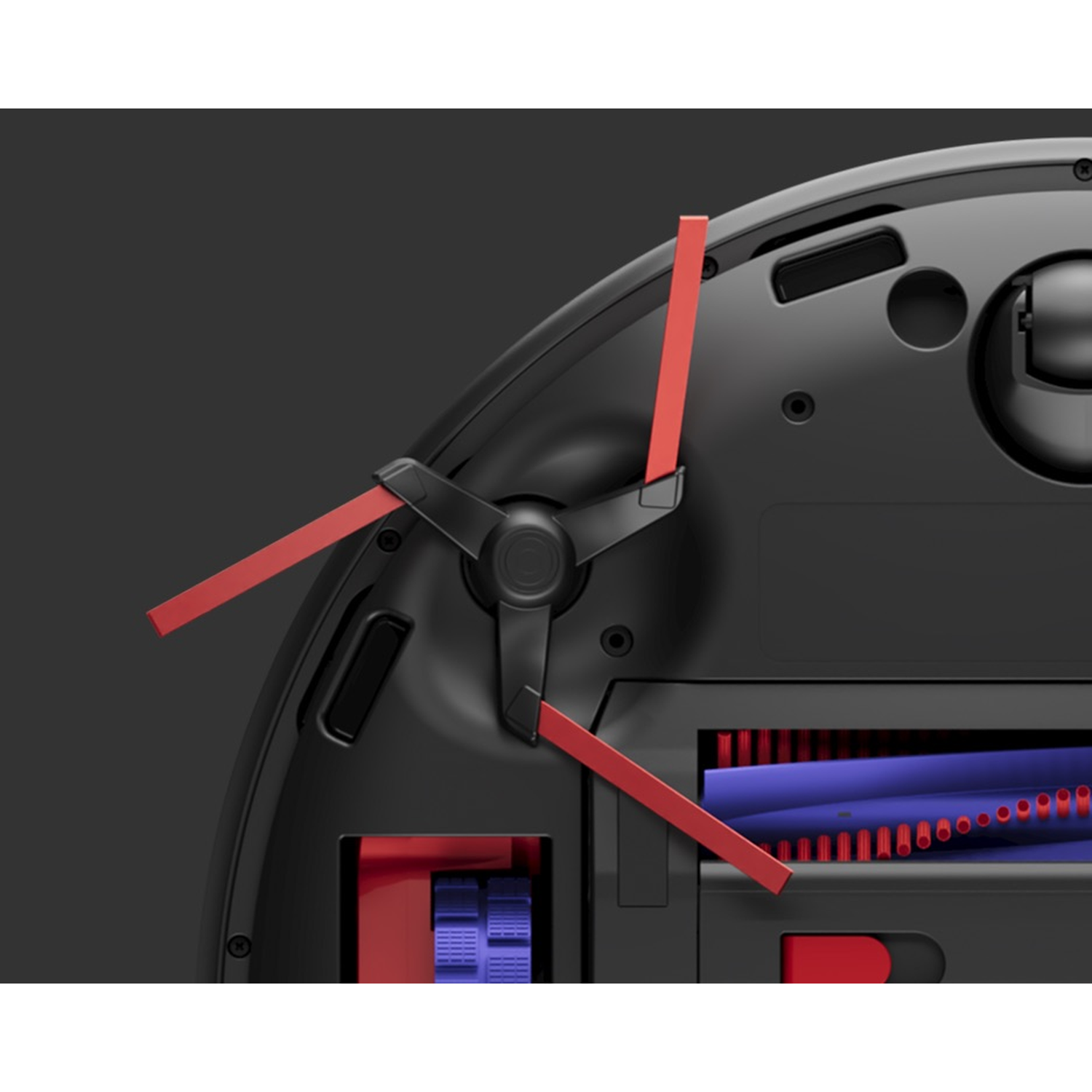 Close-up van een zwarte robotstofzuiger. Het heeft rode borstels en een blauwe rolborstel tegen een donkergrijze achtergrond.