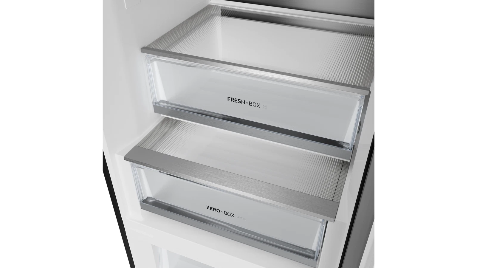 Dentro de un refrigerador, se ven dos cajones transparentes etiquetados como 'FRESH BOX' y 'ZERO BOX'. Tienen bordes metálicos.