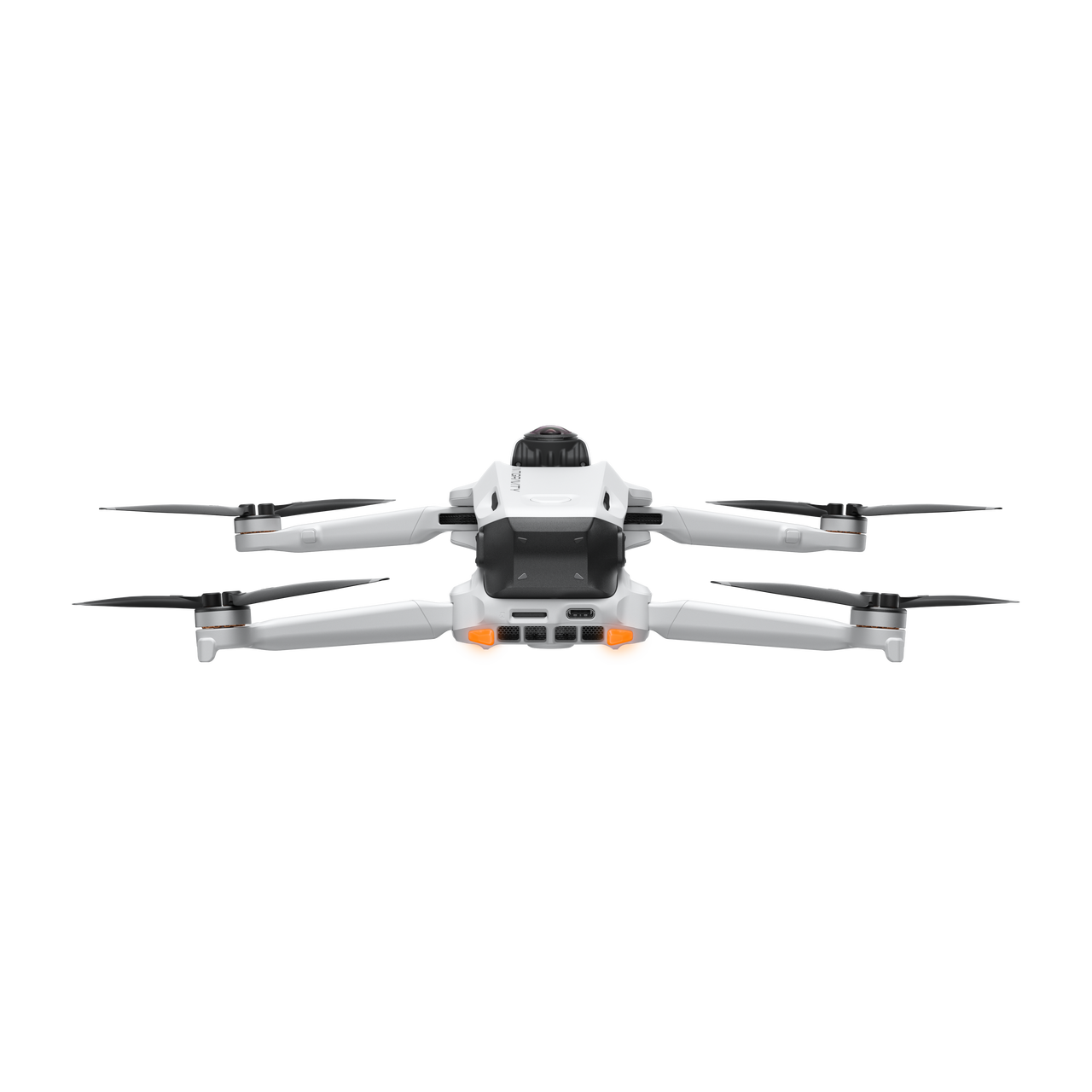 Dört pervaneli beyaz bir drone, siyah bir arka plan üzerinde ortalanmıştır. Alt kısımda turuncu ışıkları var. Drone havada.