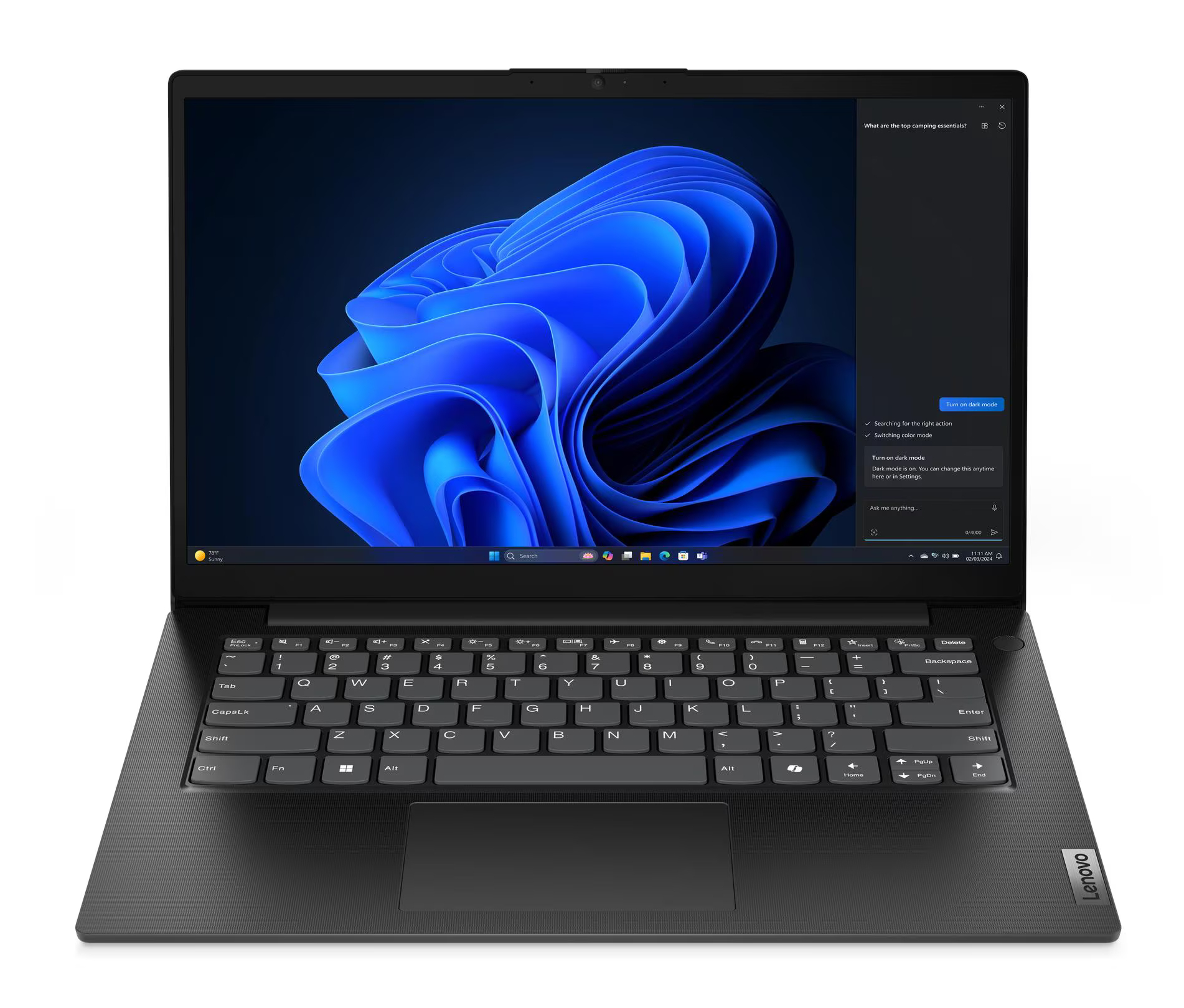 Laptop Lenovo jest otwarty, wyświetlając niebieskie abstrakcyjne tło. Klawiatura jest widoczna, a opcja trybu ciemnego jest wybrana.