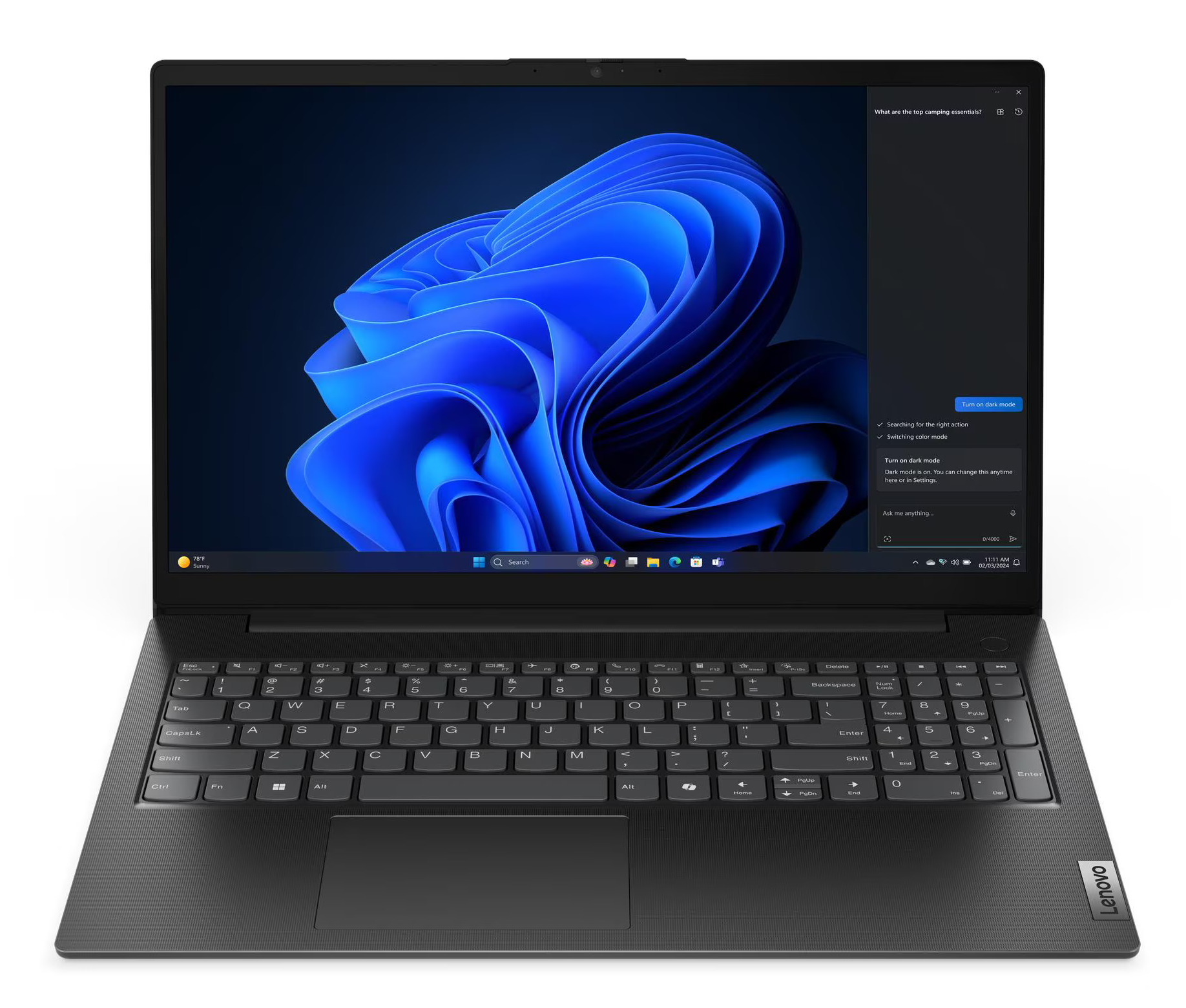 Laptop Lenovo jest otwarty, wyświetlając niebieskie abstrakcyjne tło. Klawiatura jest widoczna. Opcja trybu ciemnego jest otwarta.