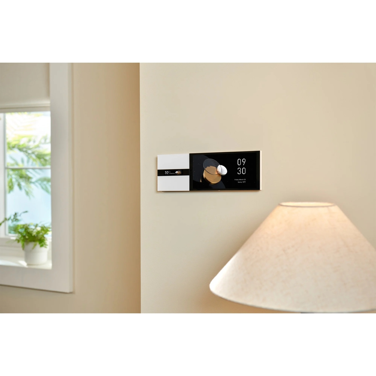 A smart home control panel is mounted on a beige wall. A window and a lamp are also visible.