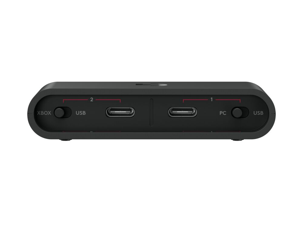 Xbox ve PC etiketli USB bağlantı noktalarına sahip siyah cihaz. Güç düğmeleri ve göstergeler içerir. Arka plan düz beyazdır.