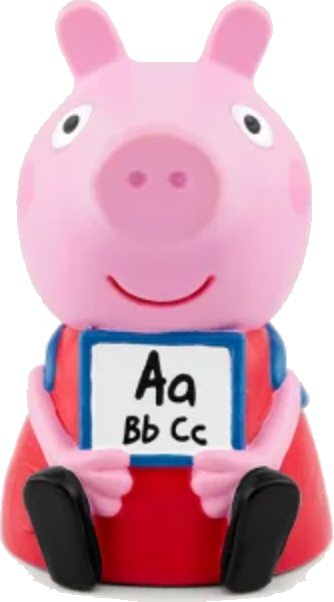 Eine rosa Schweinefigur hält ein Schild mit den Buchstaben Aa, Bb und Cc. Sie trägt ein rotes Kleid mit blauen Trägern und schwarze Schuhe.