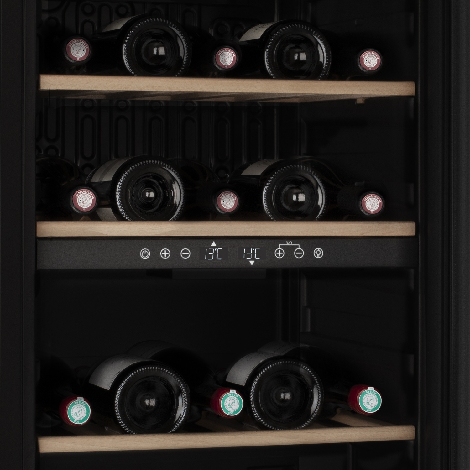 Una cantinetta piena di bottiglie di vino. Il frigorifero ha ripiani in legno e un display digitale che mostra la temperatura.