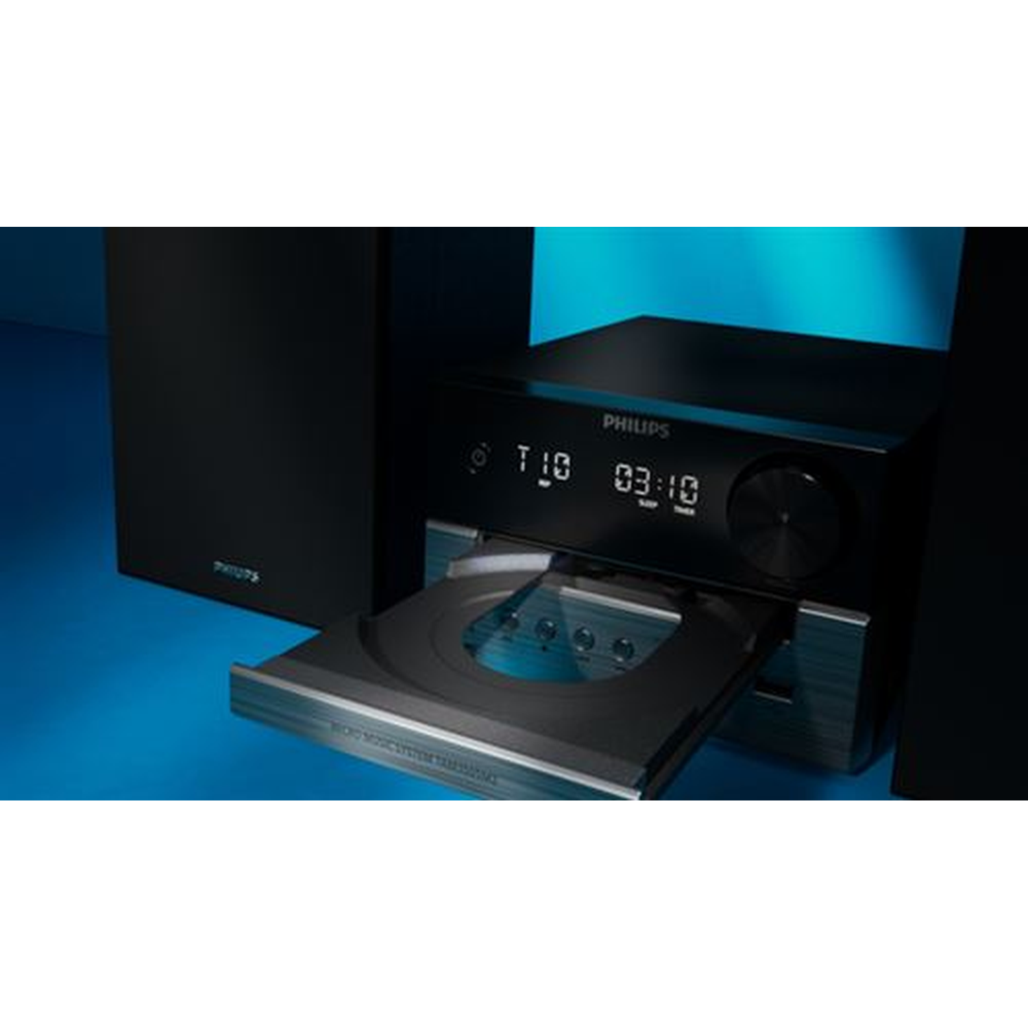 A black Philips stereo system with a CD tray open. The time 03:10 is displayed. Speakers are on the left and right sides.