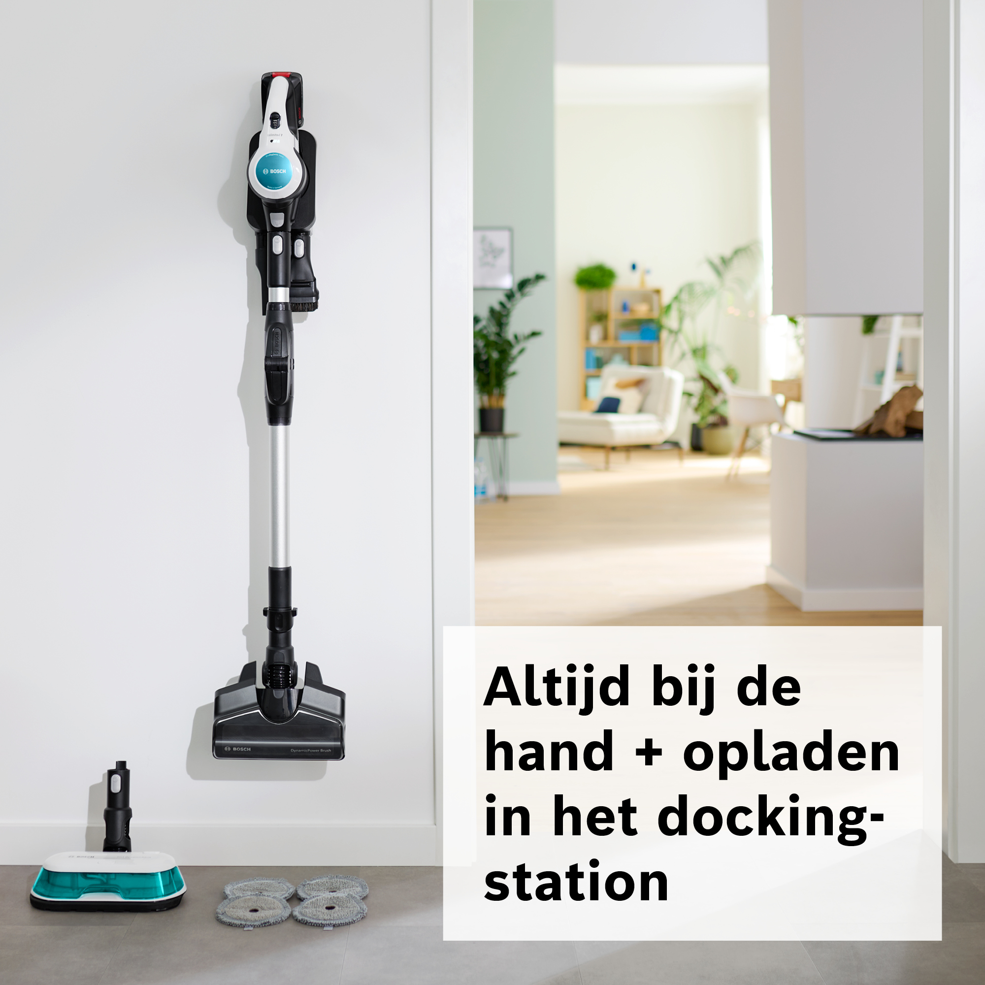 A Bosch vacuum cleaner is mounted on a white wall. The image also shows a docking station with a text in Dutch.