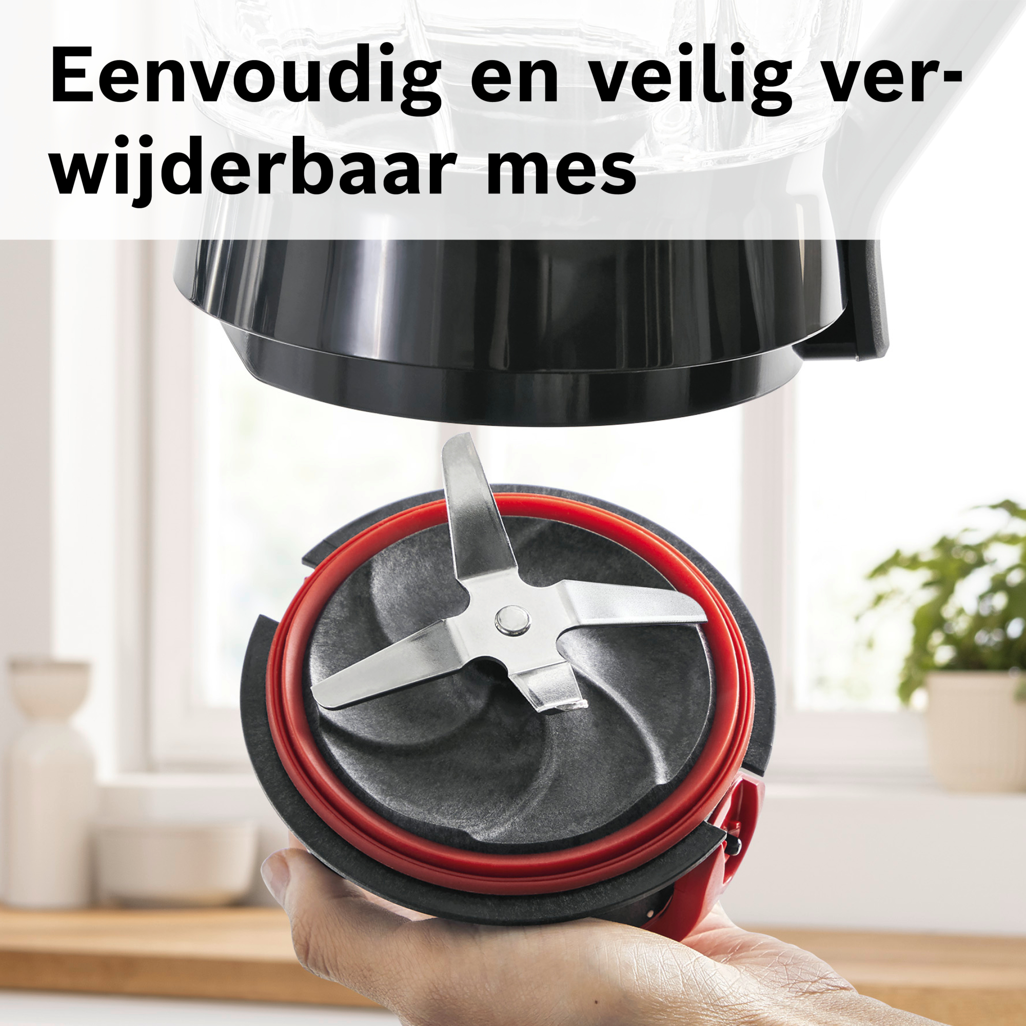 Close-up of a blender blade assembly. A hand holds the black and red blade component. Text at the top reads, 'Easy and safe removable blade.'