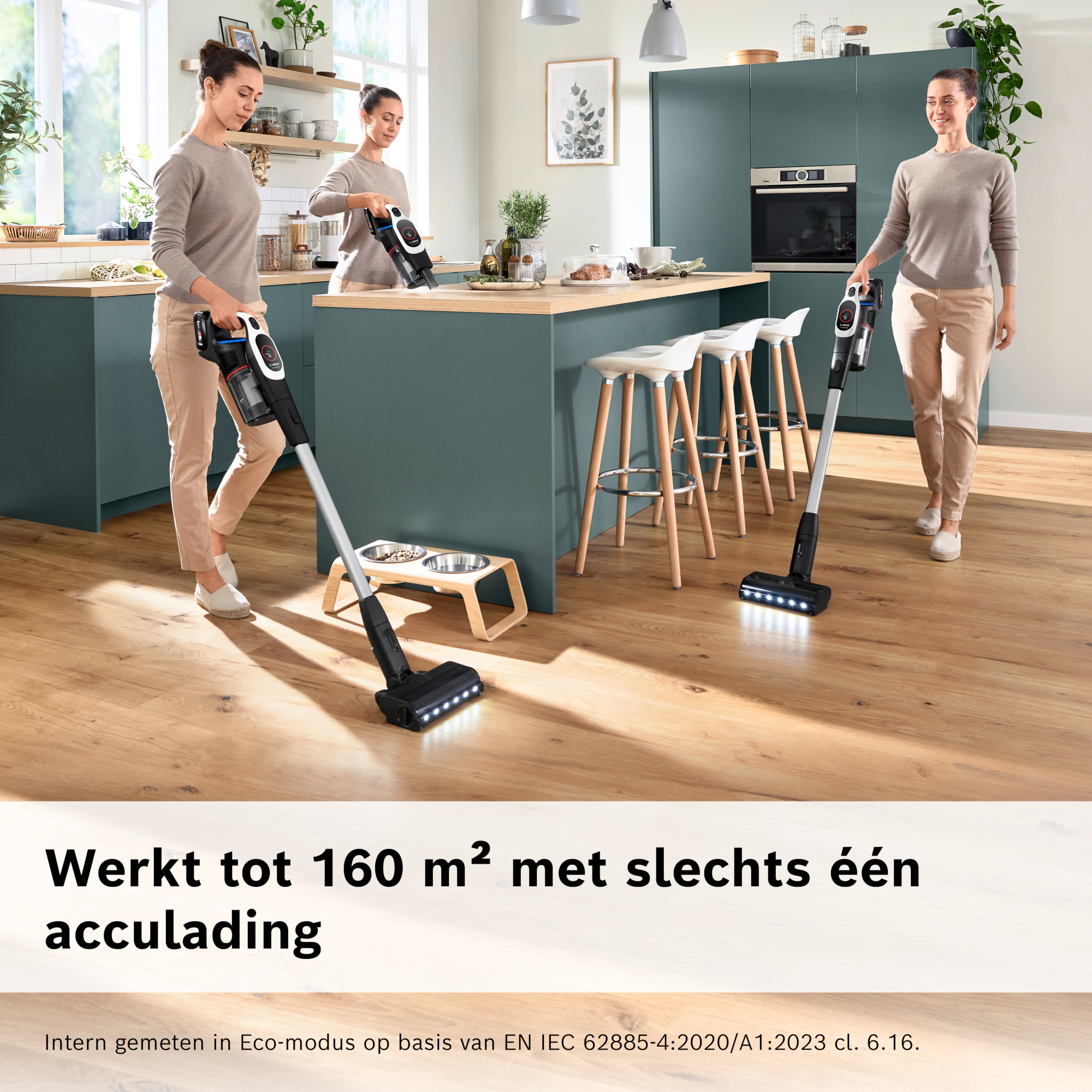 Three women vacuum a kitchen. There are dark vacuums, wooden floors, and a blue-green kitchen. Text says: Works up to 160 m².