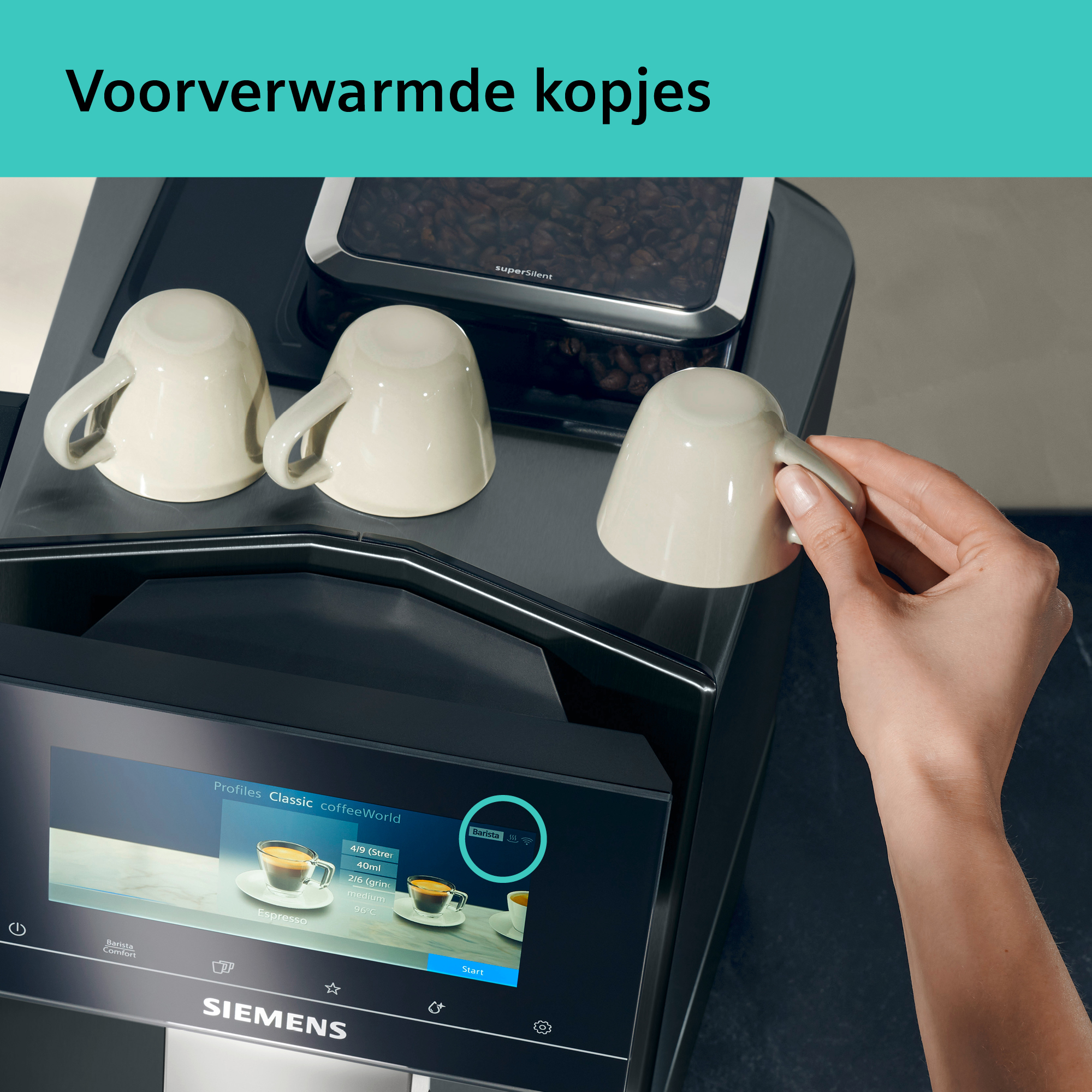A coffee machine with cups. A hand is taking a cup. The machine has a digital display and coffee beans.
